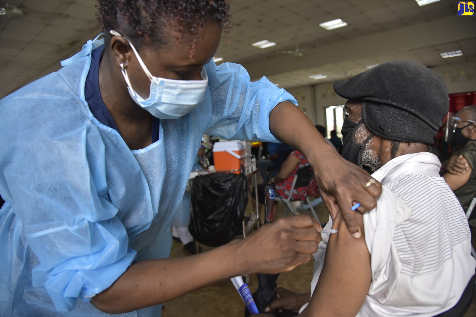Neville Watson receives his first dose of the AstraZeneca coronavirus (COVID) vaccine at the Portmore HEART Academy in St. Catherine this morning (April 10), where a vaccination blitz is underway. Nurse Georgia Reid administers the jab.