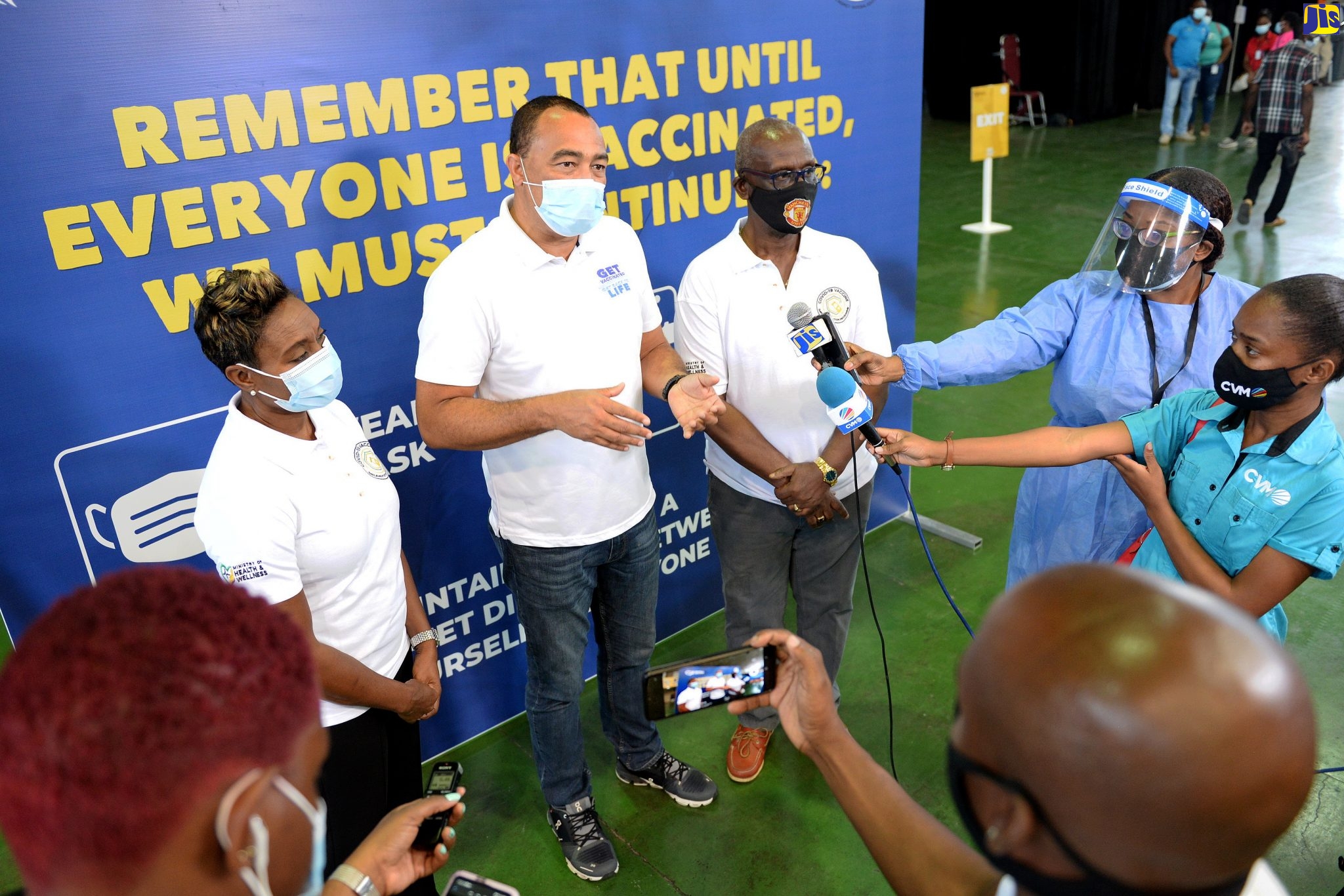 Minister of Health and Wellness, Dr. the Hon. Christopher Tufton (second left), responds to questions from journalists during the second coronavirus (COVID-19) vaccination blitz at the National Arena in St. Andrew on Saturday (April 3). From left are: State Minister in the Health and Wellness Ministry, Hon. Juliet Cuthbert-Flynn, and Minister of Local Government and Rural Development, Hon. Desmond McKenzie.
