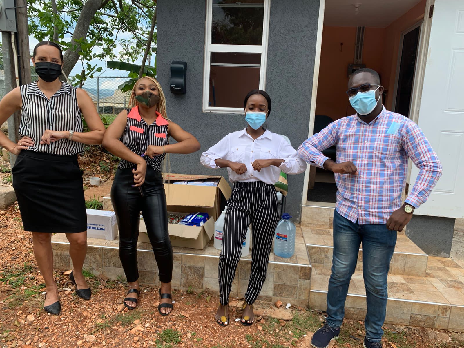 Sales and Marketing Manager at the Mandeville Hotel, Tanielle Elliott (left), and University student, Ramona Geohaghan (second left),  with

volunteers, Ruth-Ann Samuels and Tajay Eccleston,  at the Manchester Infirmary to deliver supplies.