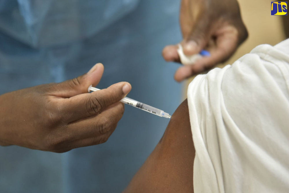 A nurse administers the AstraZeneca vaccine to a member of the public at the vaccination blitz, held at the Portmore HEART Academy on Saturday, April 10