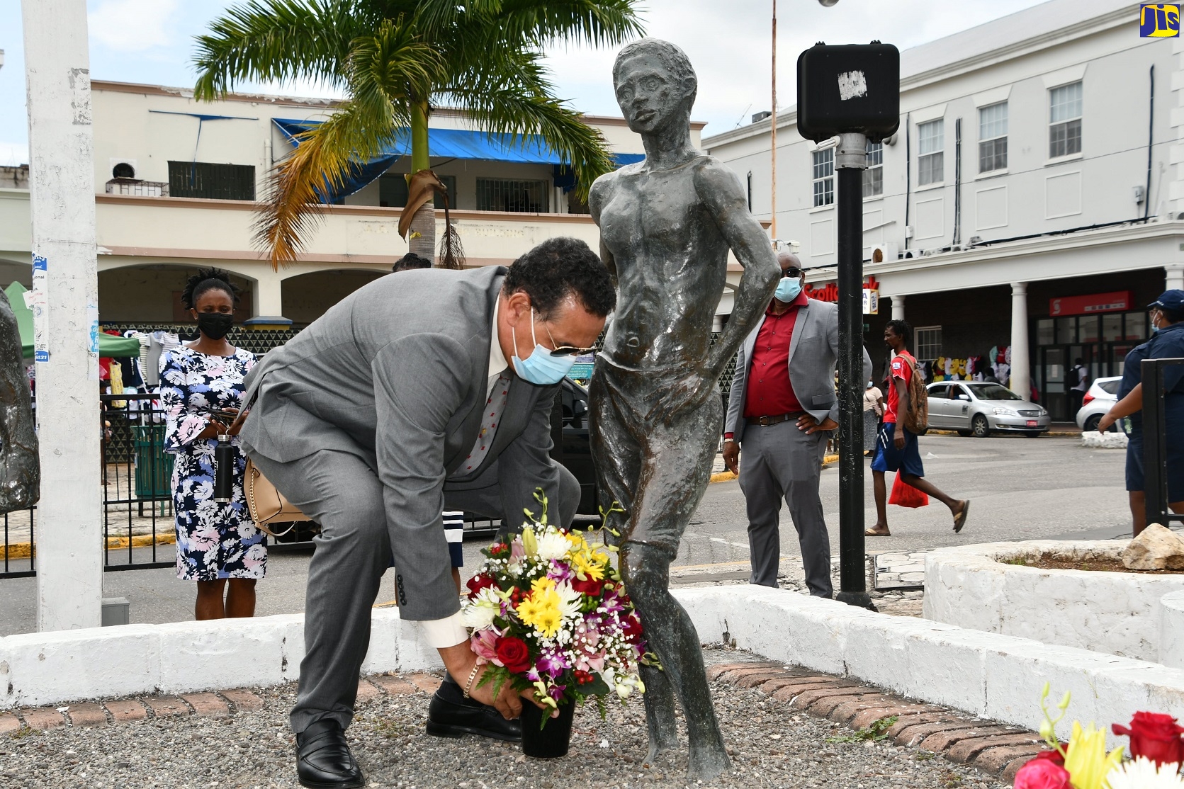 State Minister in the Ministry of Local Government and Rural Development, Hon. Homer Davis, places flowers in honour of National Hero, The Right Excellent Samuel Sharpe, during a ceremony in Sam Sharpe Square, Montego Bay, St. James, on Sunday, May 23.