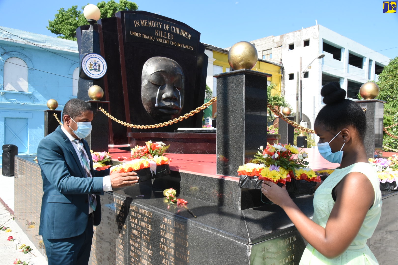Kingston’s Mayor, Senator Councillor Delroy Williams (left), and Kingston and St. Andrew Municipal Corporation (KSAMC) Youth Councillor Representative for the Springfield Division, Reajean Bennett, lay wreaths at the Secret Gardens Monument in downtown Kingston, during a ceremony on Sunday (May 2) in memory of the nation’s children who have died under violent/tragic circumstances. The ceremony formed part of the Corporation’s activities commemorating Child Month during May under the theme: ‘I Strive to Overcome Adversities with Resilience’ (I.S.O.A.R.).