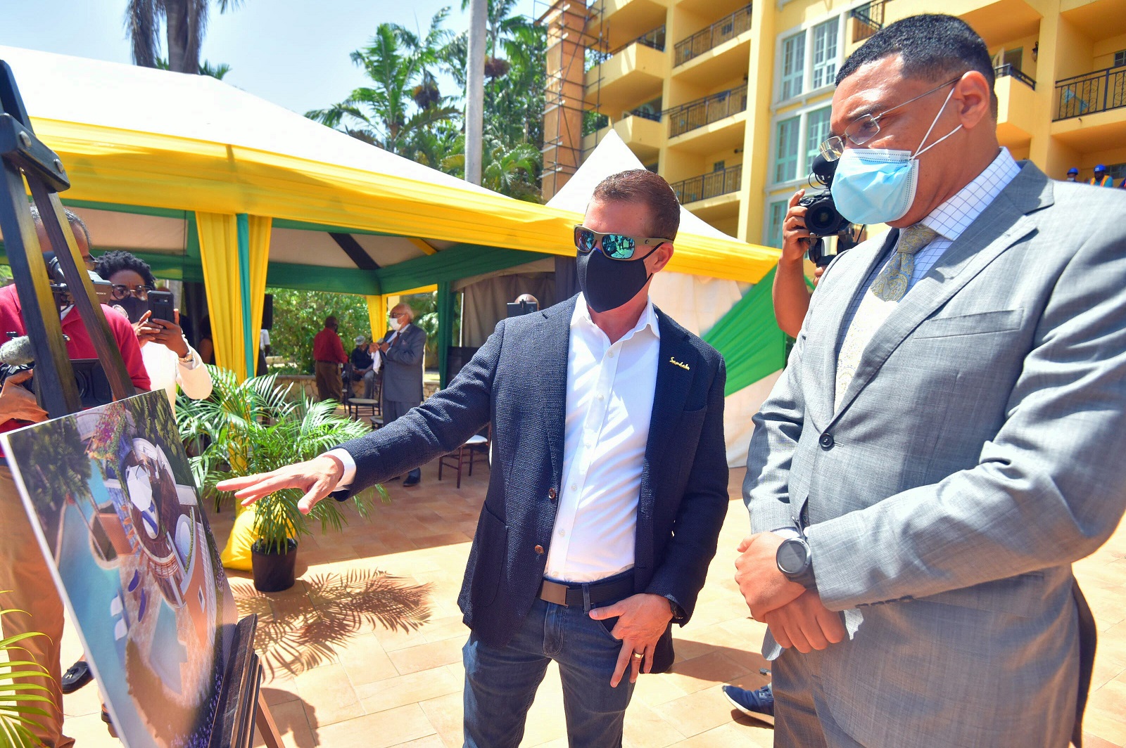 Prime Minister, the Most Hon. Andrew Holness (right) looks as Executive Chairman of Sandals Resorts International, Adam Stewart, highlights plans for the new Sandals Dunn’s River in St. Ann, for which ground was broken on Wednesday, May 26.