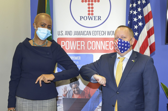 The U.S. Embassy’s Chargé d’Affaires John McIntyre (r) shares an elbow bump with Minister of Education, Youth and Information, The Honorable Fayval Williams, ahead of the launch of the Women in EdTech POWER Connect 

