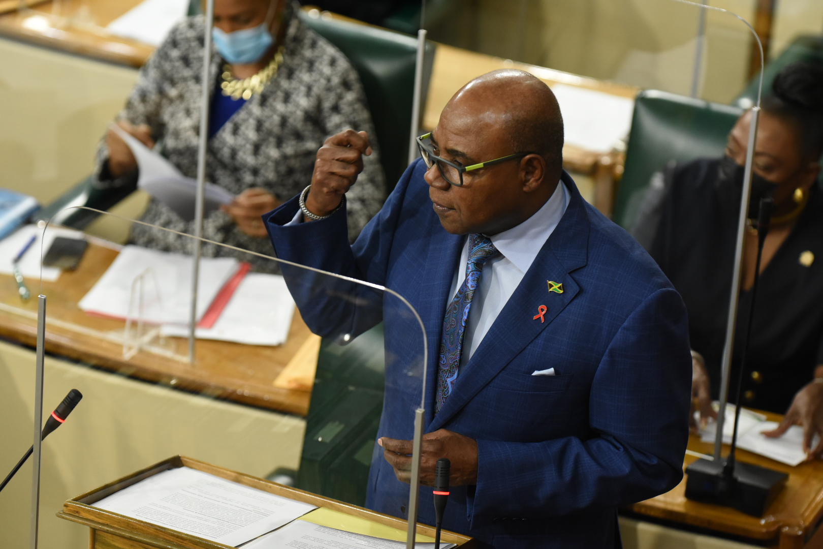 Minister of Tourism and Leader of Government Business in the House of Representatives, Hon. Edmund Bartlett,  closing the 2021/22 Sectoral Debate in the Lower House, on Tuesday (June 15). Also pictured in the background (from left) are Minister of Education, Youth and Information, Hon. Fayval Williams; and Minister of Culture, Gender, Entertainment and Sport, Hon. Olivia Grange.

