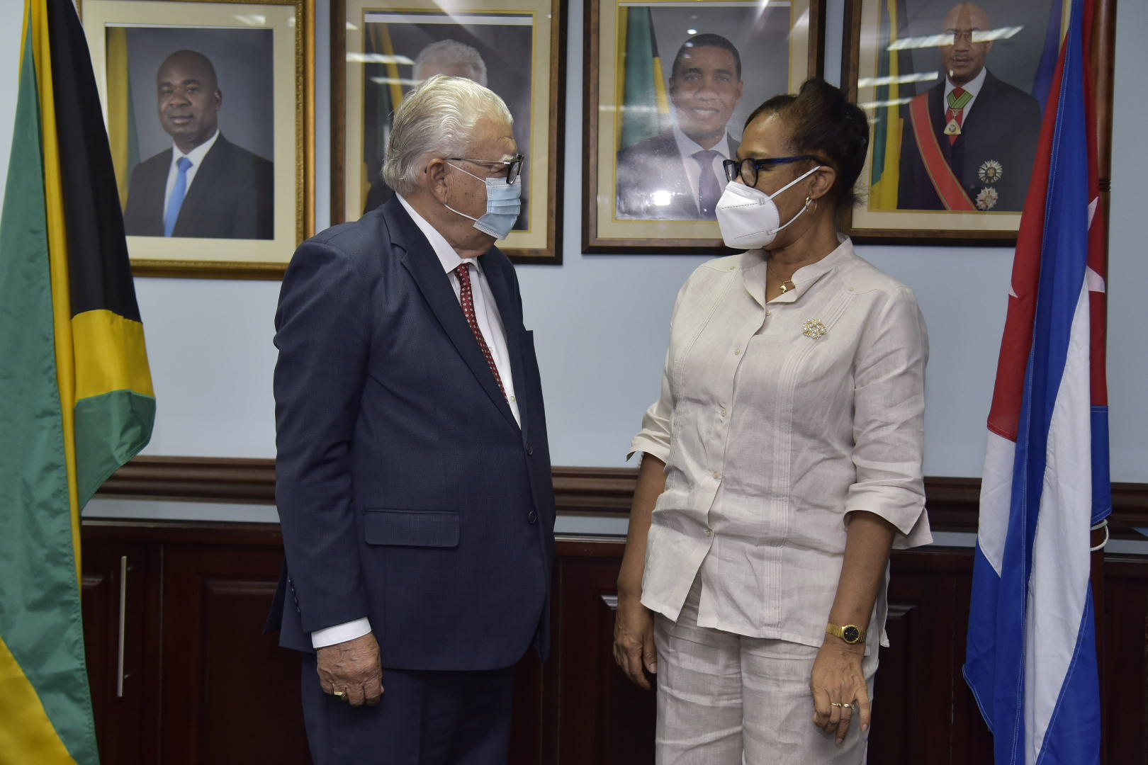 Minister of Labour and Social Security, Hon. Karl Samuda, converses with outgoing Ambassador of the Republic of Cuba to Jamaica, Her Excellency Inés Fors Fernández (right), during her farewell visit to the Minister at the National Insurance Fund's New Kingston offices, on June 29. 

