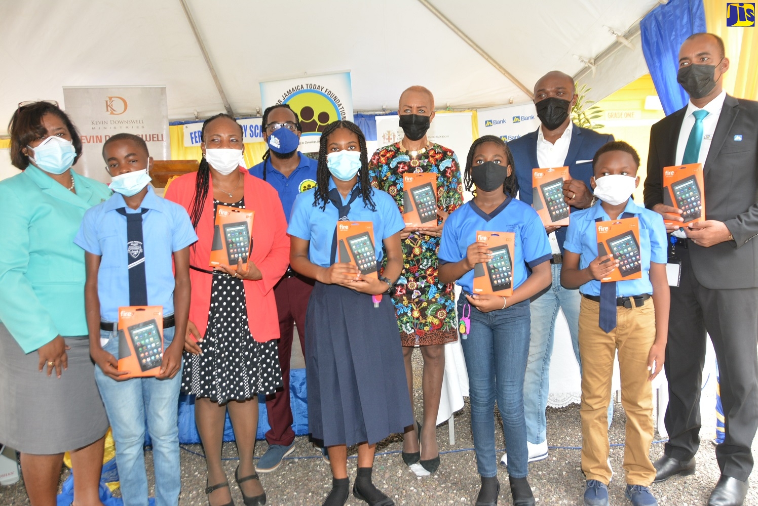 Education, Youth and Information Minister, Hon. Fayval Williams (fifth right), is joined by staff and education stakeholders at Ferris Primary School in Westmoreland, on Thursday, June 17, when 21 tablets valued at $260,000 were handed over to the institution by several non-profit organisations.