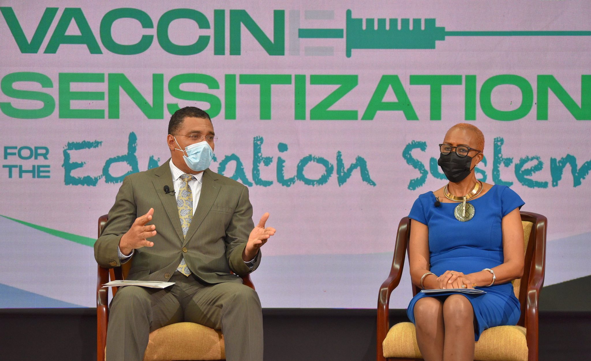 Prime Minister, the Most Hon. Andrew Holness (left),  fields questions from the public during a virtual Town Hall on Vaccine Sensitisation for the Education System on Friday (June 11). Also pictured is Minister of Education, Youth and Information, Hon. Fayval Williams.