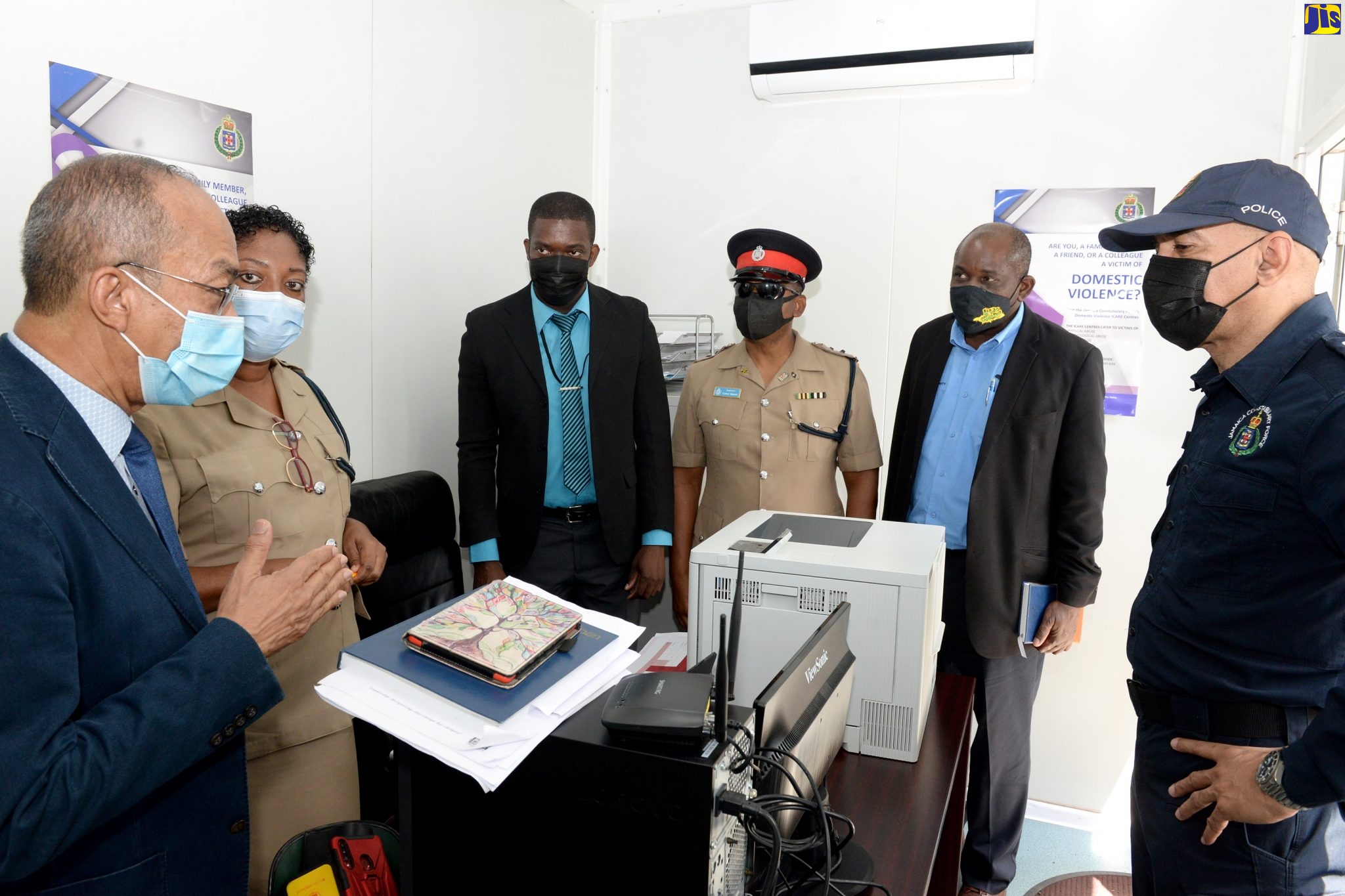 Deputy Prime Minister and Minister of National Security, Hon. Dr. Horace Chang (left), in discussion with (from 2nd left), National Coordinator for the Jamaica Constabulary Force’s (JCF) Domestic Violence Intervention Centres, Woman Inspector Jacqueline Dillon Grant; Manager for the Matilda’s Corner Police Station Domestic Violence Intervention Centre, Corporal Kerron Harris; Commanding Officer for the Station, Inspector Earl Grant; Permanent Secretary in the National Security Ministry, Courtney Williams; and Police Commissioner, Major General Antony Anderson, during Friday’s (June 18) tour of the facility.