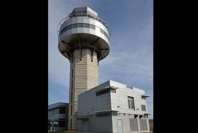 The air traffic control tower at the Norman Manley International Airport, the location from which aerodrome controllers guide aircraft into the airport after taking over from the air traffic controllers at the Kingston Air Traffic Control Centre.  

