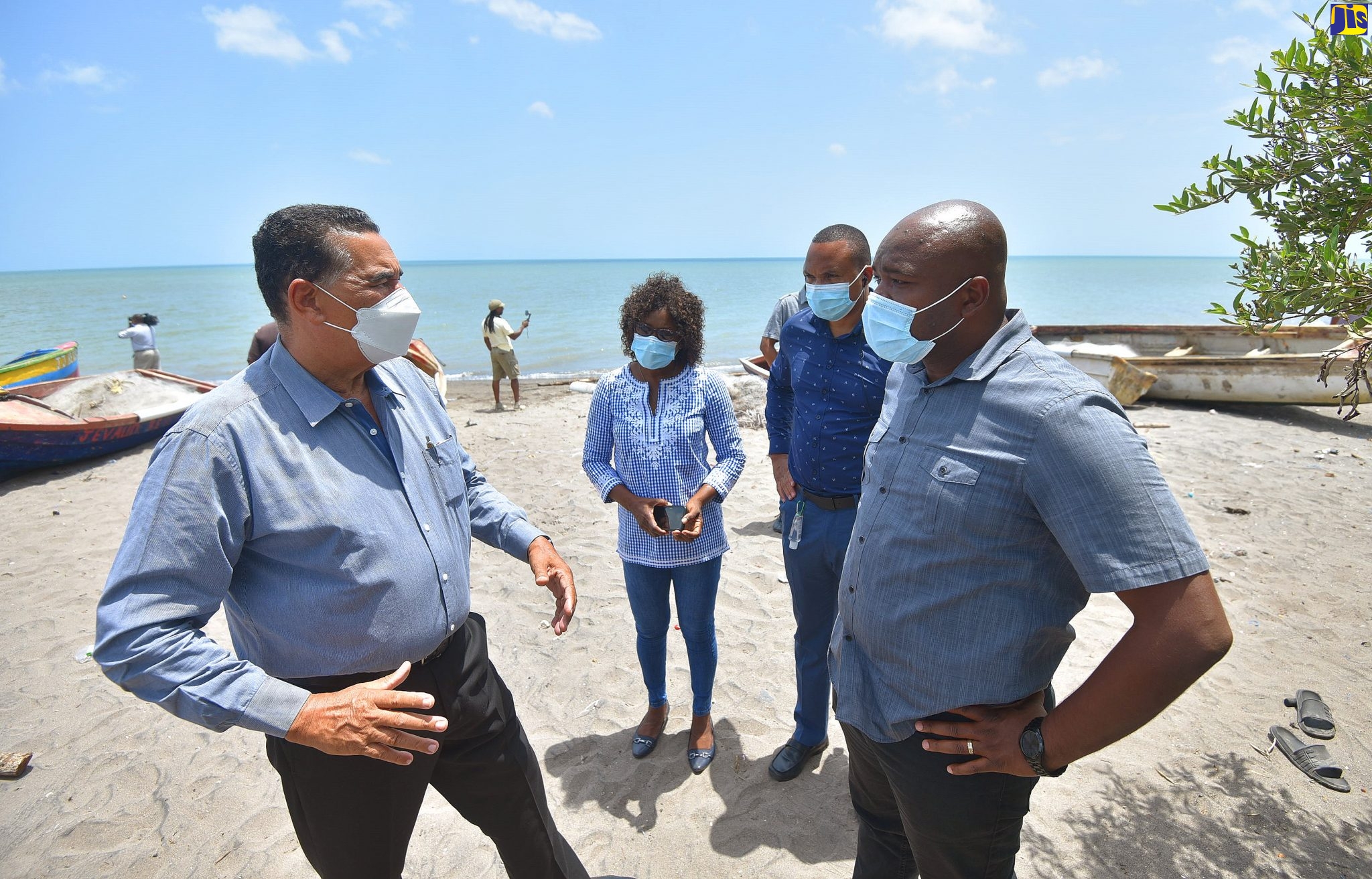 Minister of State in the Ministry of Local Government and Rural Development, Hon. Homer Davis (left), in conversation with Member of Parliament for South West Clarendon, Lothan Cousins (right), while touring a section of the community of Banks in the parish on July 22. Others (from left) are: Councillor for the Race Course Division, Pauline Reynolds, and Chief Executive Officer for the Clarendon Municipal Corporation, Rohan Blake.