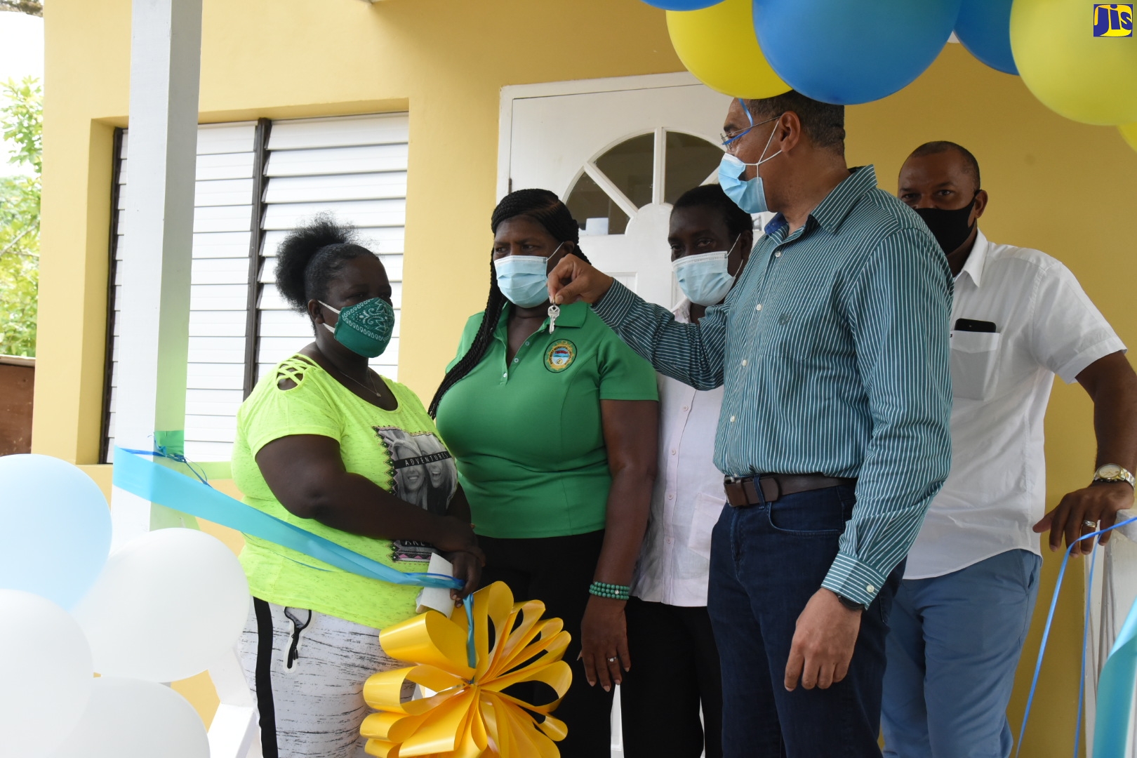 Prime Minister, the Most Hon. Andrew Holness (second right), displays keys for the new three-bedroom house handed over to Dawnette Henry (left), at a  social housing ceremony, held on July 16, in Farm Pen, St. Mary. Sharing the moment (from second left) are: Councillor for the Carron Hall Division, Doreen Hutchinson; Member of Parliament for Western St. Mary, Hon. Robert Montague, and Mayor of Port Maria, Councillor Richard Creary.