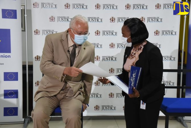 Restorative Justice Coordinator, Andriene Lindsay, speaks with Justice Minister, Hon. Delroy Chuck, during a Justice Ministry Virtual Town Hall last year.

