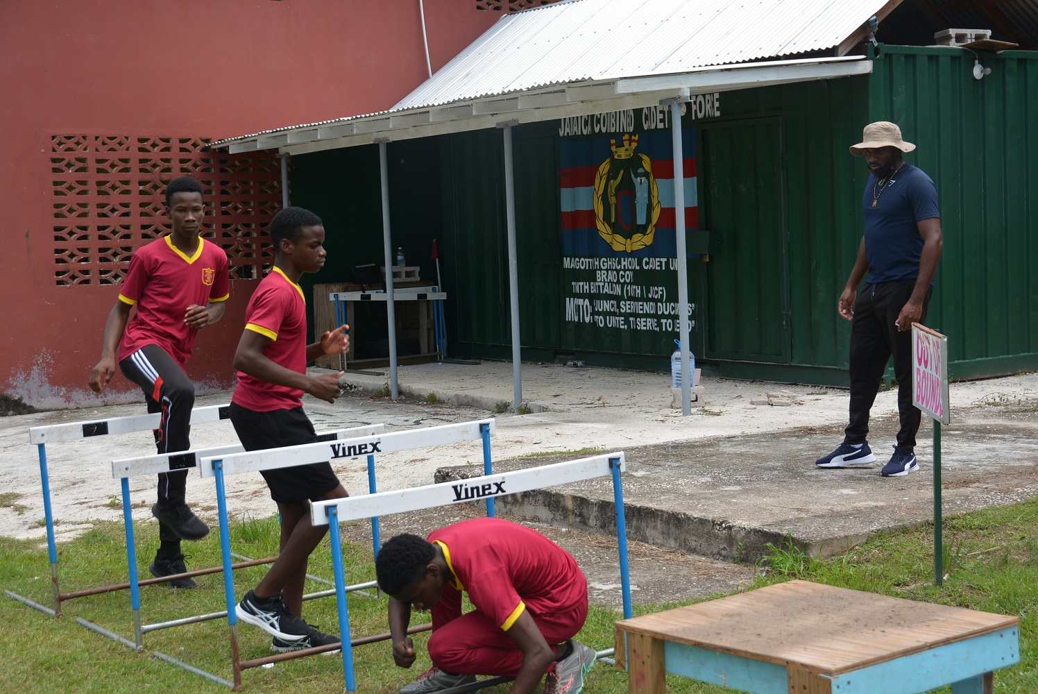 Head Coach of the Maggotty High School’s track and field team in St. Elizabeth, Terone Miller, oversees the workout by his track athletes, Zachary Wallace (left), Charehon Connally (second left) and Yoshane Bowen, who participated in the recent 2021 ISSA/GraceKennedy Boys and Girls' Athletics Championship.