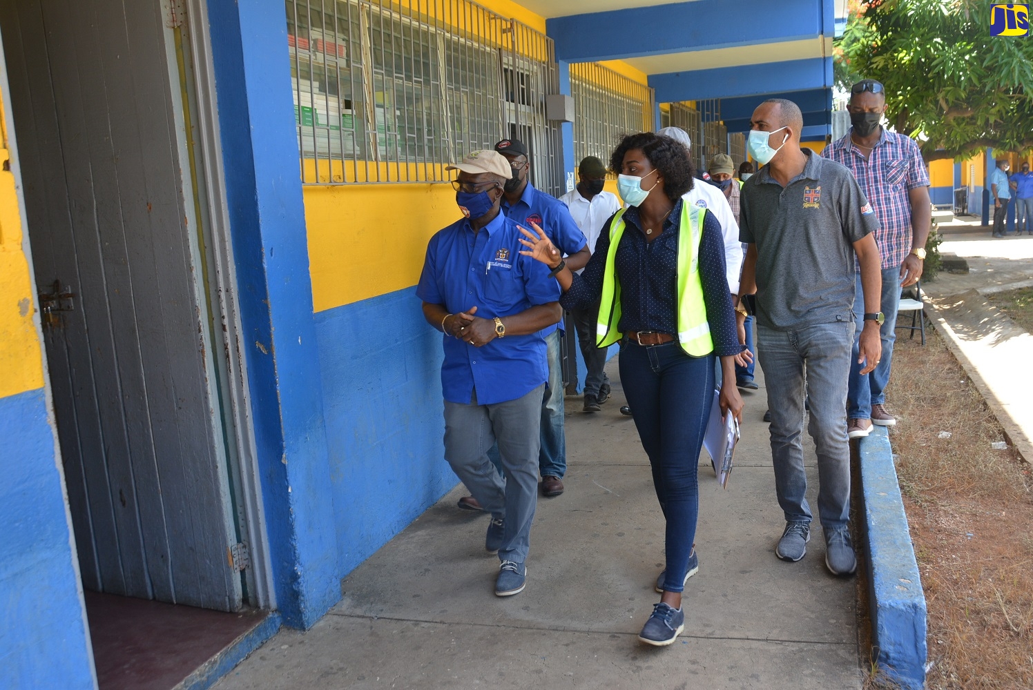 Minister of Local Government and Rural Development, Hon. Desmond McKenzie (left), is accompanied by Parish Coordinator for Disaster Preparedness at the St. Elizabeth Municipal Corporation, Ornella Lewis (centre), and Principal of St. Elizabeth Technical High School (STETHS), Keith Wellington, during a  tour of the emergency shelter at the institution, on Friday, July 16.