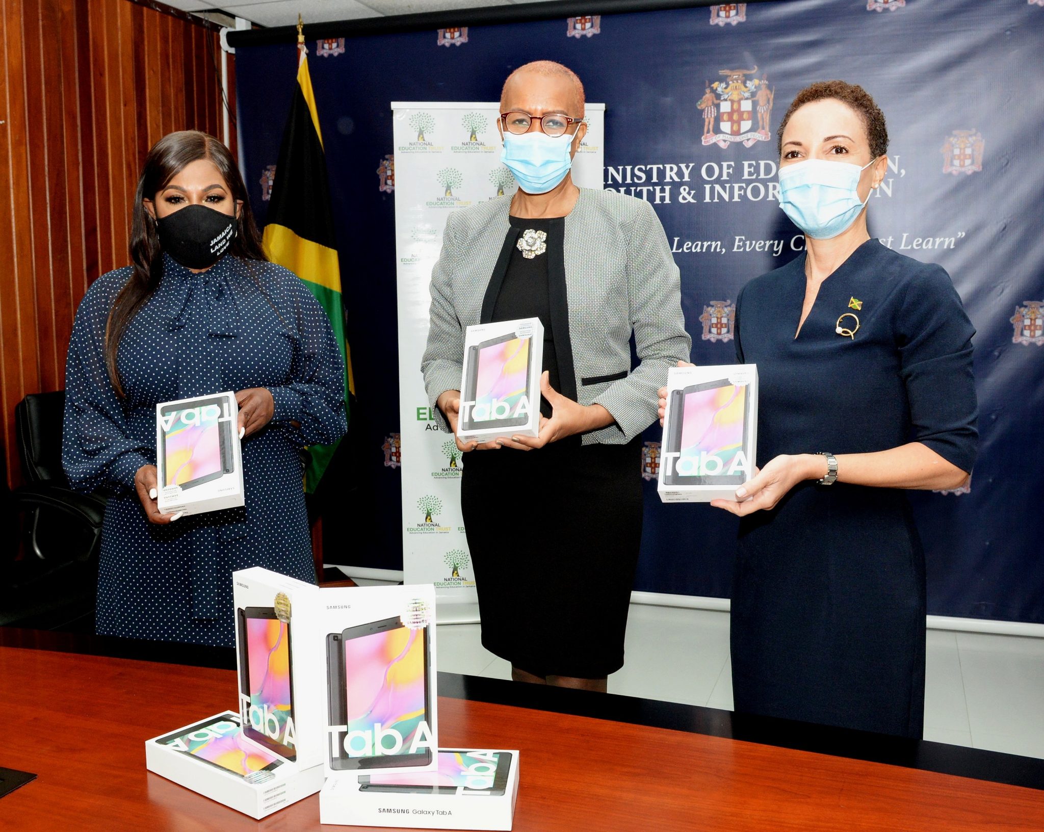 Minister of Education, Youth and Information, Hon. Fayval Williams (centre), Jamaica’s Consul General to New York, Alsion Roach Wilson (left); and Minister of Foreign Affairs and Foreign Trade, Senator the Hon. Kamina Johnson Smith (right), display tablets during a handover ceremony at the Education Ministry's National Heroes Circle location in Kingston on Wednesday (July 21). Over 1,400 tablets and laptops were donated by the Consul General, for distribution to needy students across the island. 