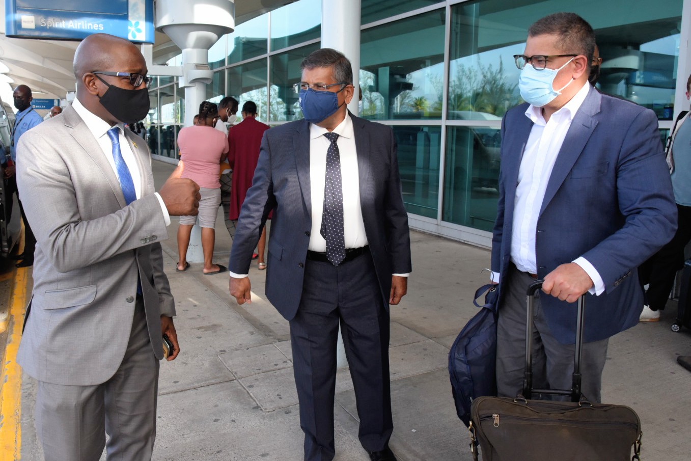 Minister of Housing, Urban Renewal, Environment and Climate Change,  Hon. Pearnel Charles Jr. (left), greets President for the 26th United Nations Climate Change Conference, the Rt. Hon. Alok Sharma (right), at the Norman Manley International Airport on July 5.  Also welcoming Mr. Sharma is  British High Commissioner to Jamaica, His Excellency Asif Ahmad.