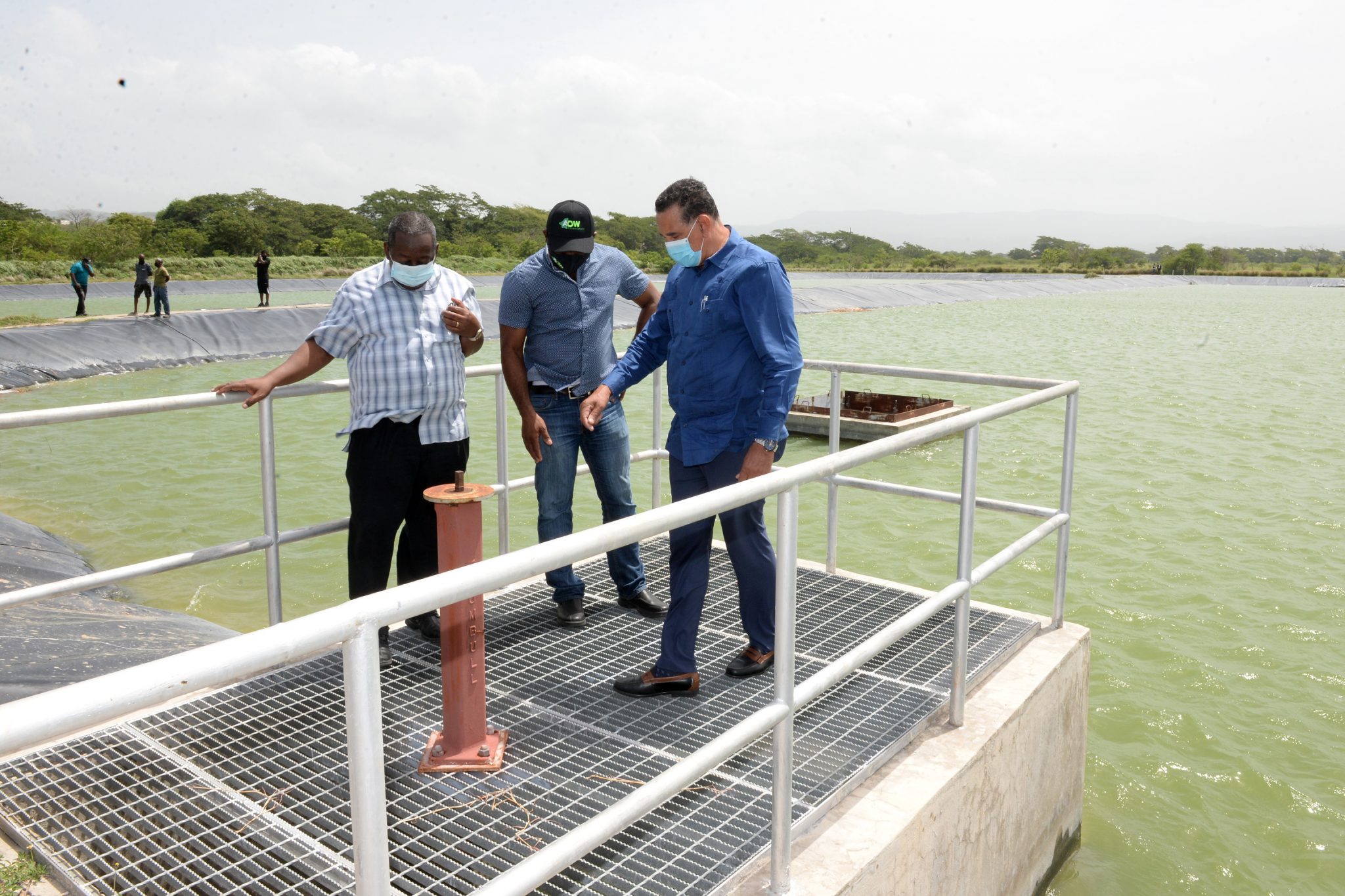 State Minister in the Ministry of Local Government and Rural Development, Hon. Homer Davis (right), in discussion with Managing Director of the Rural Water Supply Limited (RWSL), Audley Thompson (left), and Member of Parliament for South Central St. Catherine, Dr. Andrew Wheatley, while on a tour of the RWSL Artificial Underground Recharge System in Innswood, St. Catherine, on July 13.