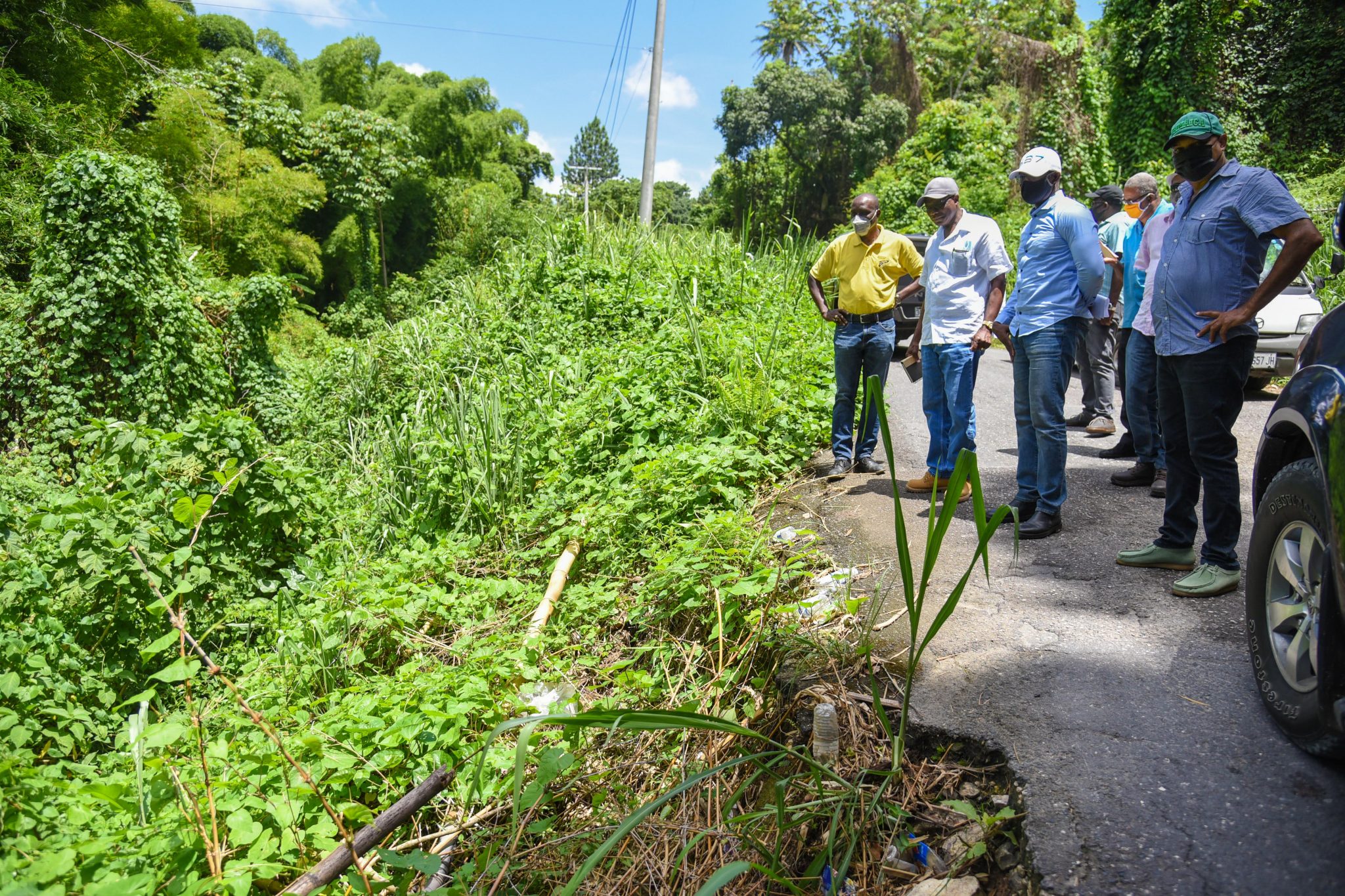 Minister without Portfolio in the Ministry of Economic Growth and Job Creation, Hon. Everald Warmington (second left), looks at a breakaway section of road during a tour of the road network in sections of Clarendon North on August 4. Other members of the touring party (from left) are Manager, Communication and Customer Service, National Works Agency, Stephen Shaw; Member of Parliament for Clarendon North, Dwight Sibblies; and  Councillor for the Kellits Division, Noel Nembhard.

