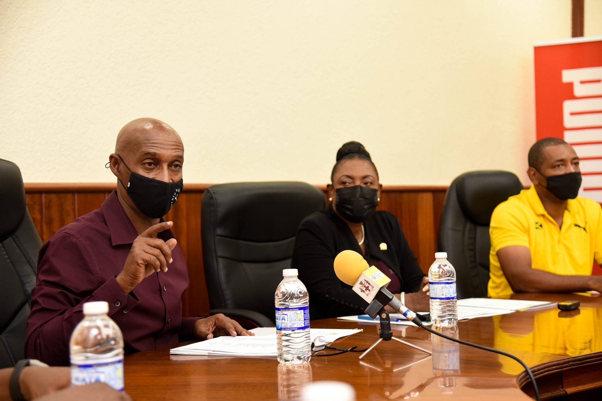 Minister of Culture, Gender, Entertainment and Sport, Hon. Olivia Grange (centre), listens as Jamaica Athletics Administrative Association (JAAA) President, Garth Gayle (left), speaks during a recent send-off ceremony at the JAAA’s offices in Kingston for athletes representing Jamaica at the 2021 World Athletics Under 20 Championships 2021, being held from August 17 to 22 in Nairobi, Kenya. Also listening is Technical Leader for the delegation’s Management Team, David Riley.

