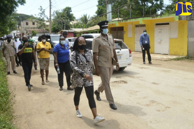Member of Parliament for Trelawny Northern, Tova Hamilton (left) along with Commanding Officer of the Trelawny Police Division, Superintendent Carlos Russell (right), lead a peace walk in the community of Wakefield on Independence Day (August 6).