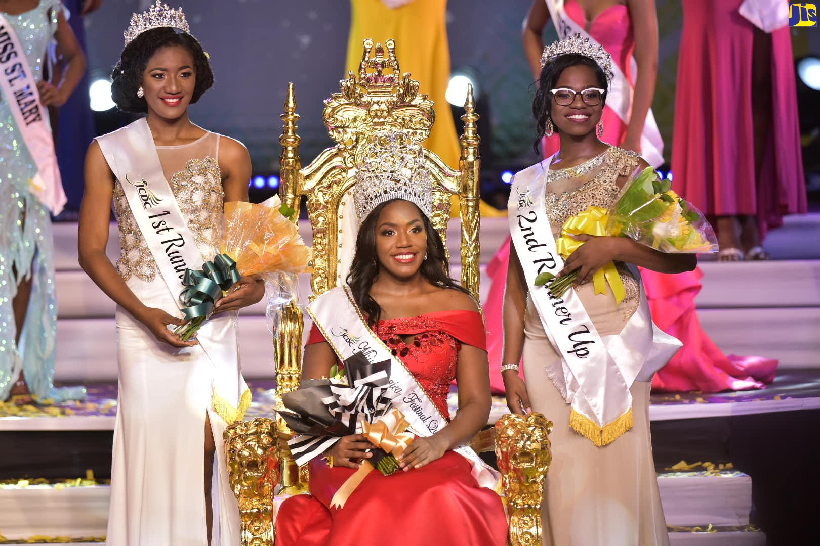 Miss Jamaica Festival Queen 2021, Dominic Reid (seated), is flanked by first runner in this year’s competition, Miss Westmoreland, Nakinskie Robinson (left), and Miss St. James, Morganne Kellier, during Sunday’s (August 1) coronation at the Little Theatre in Kingston. Ms. Reid, a dental surgeon who represented Manchester, is the daughter of 1991 Festival Queen, Karlene Kelly-Reid. The Festival Queen competition, which forms part of the Jamaica’s Emancipation and Independence celebrations, is organised by the Jamaica Cultutral Development Commission (JCDC).   