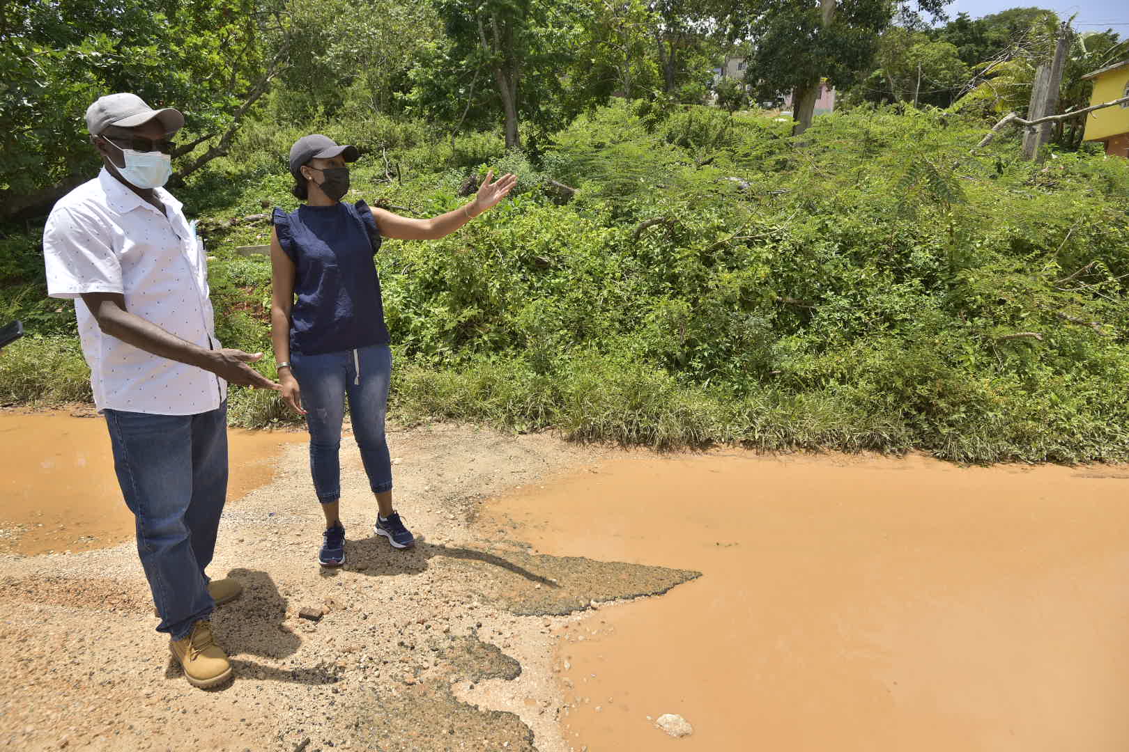Minister without portfolio in the Ministry or Economic Growth and Job Creation, Hon. Everald Warmington (left), and Member of Parliament for Central Manchester, Rhonda Moy Crawford, in conversation while on a tour of the constituency, on Thursday (August 25). Photo: Donald De La Haye

