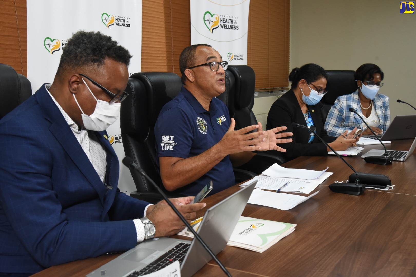 Minister of Health and Wellness, Dr. the Hon. Christopher Tufton (second left), emphasises a point during the virtual COVID Conversations press conference on August 12. Listening (from left) are: Permanent Secretary in the Ministry, Dunstan Bryan; Chief Medical Officer, Jacquiline Bisasor- McKenzie; and Director of Family Health Services in the Ministry, Dr. Melody Ennis.
