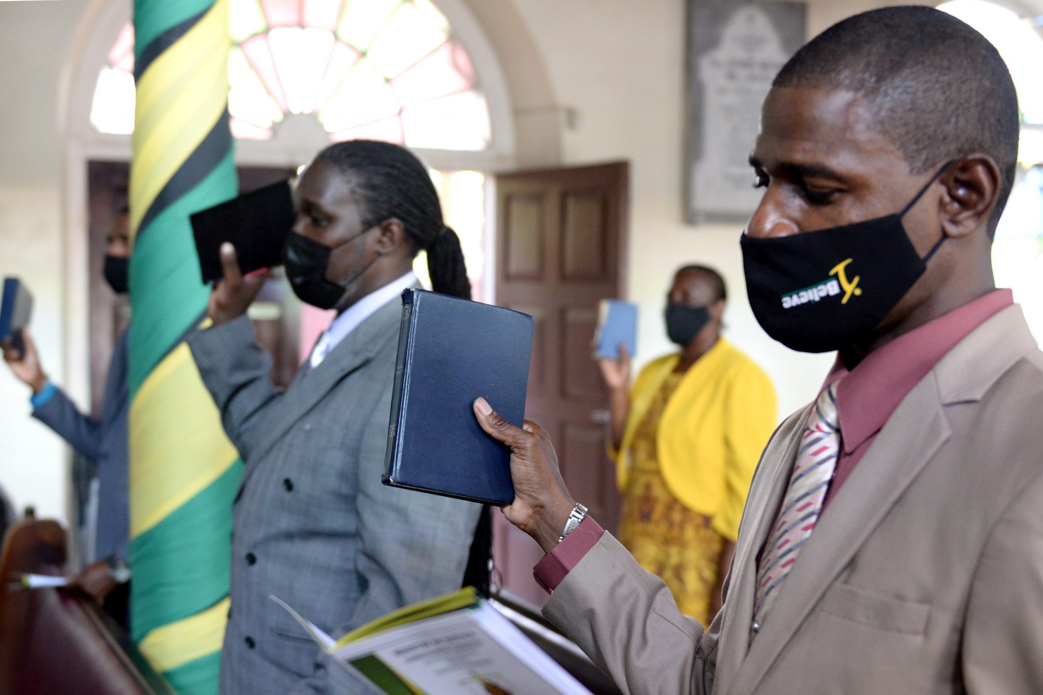 Newly commissioned Justices of the Peace for St. Catherine (from left), Jeffrey McKenzie and Dwight Stewart take the Oath of Office during a virtual commissioning ceremony broadcast from the Phillippo Baptist Church in the parish on Wednesday (August 11).  They were among 207 JPs who were sworn in during the ceremony. The majority of the JPs participated virtually. 

