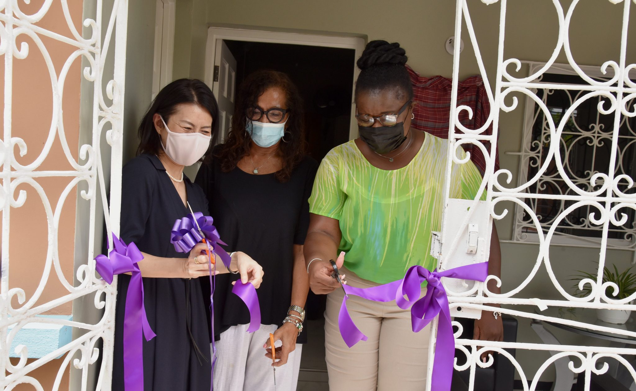 Director of the National Shelter Programme in the Ministry of Culture, Gender, Entertainment and Sport, Dr. Tamika Peart (right), cuts the ribbon to officially open the $14 million facility for abused women in St. Andrew today (August 19). Also sharing in the occasion are: First Secretary and Director of Economic and Cooperation at the Embassy of Japan, Noriko Oshima (left), and Chairman and Founder of Woman Inc, Angela Stewart (centre). Establishment of the shelter was done by Woman Inc, with funding from the Embassy of Japan.

