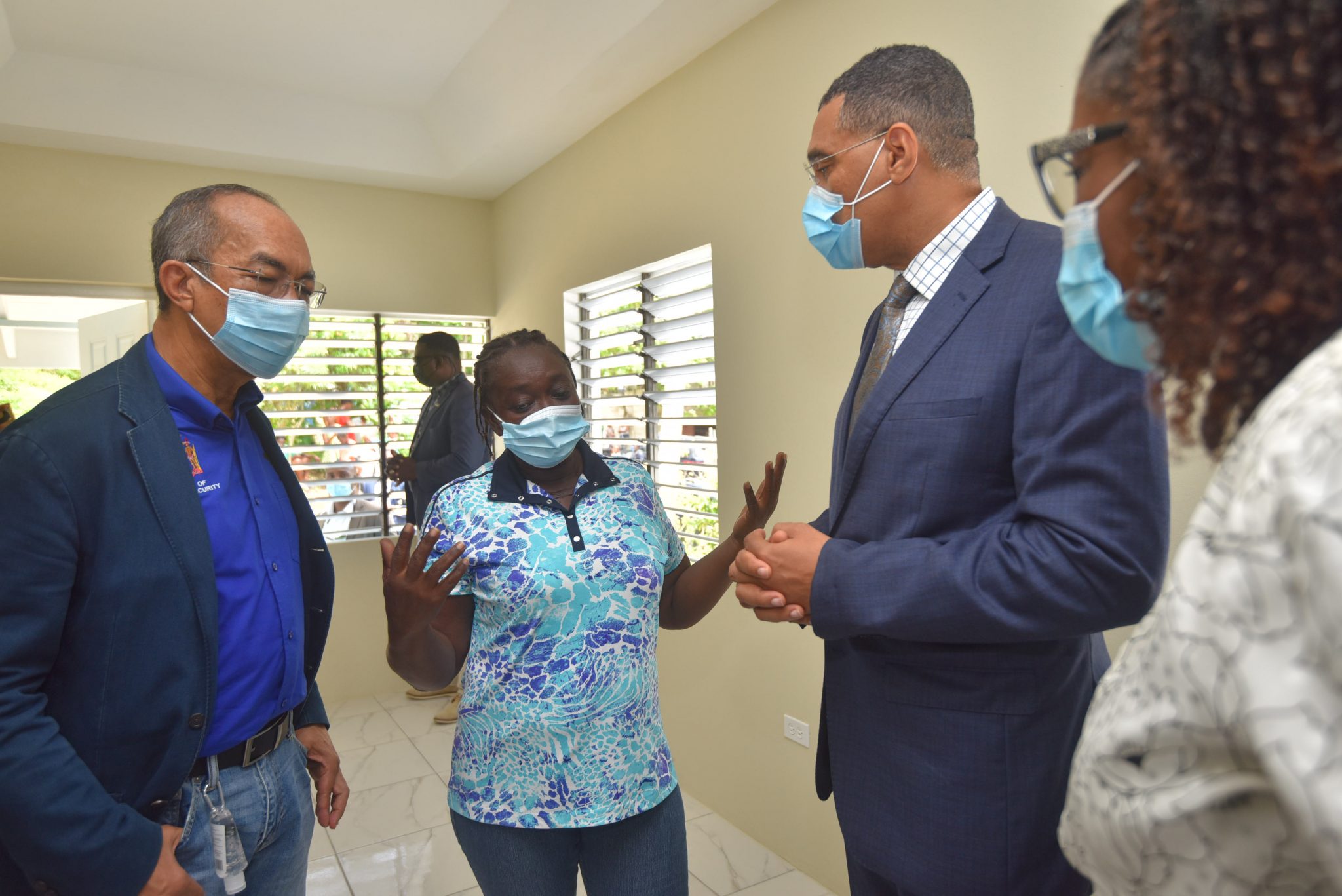 Prime Minister, the Most Hon. Andrew Holness (third left), interacting with resident Marva Mason (second left), during a recent tour of a new three-bedroom house that was handed over to her in Quarry, St. James, under government’s new Social Housing Programme. Looking on are Deputy Prime Minister & Minister of National Security, Hon. Dr. Horace Chang (left); and Permanent Secretary in the Ministry of Economic Growth and Job Creation, Audrey Sewell.   