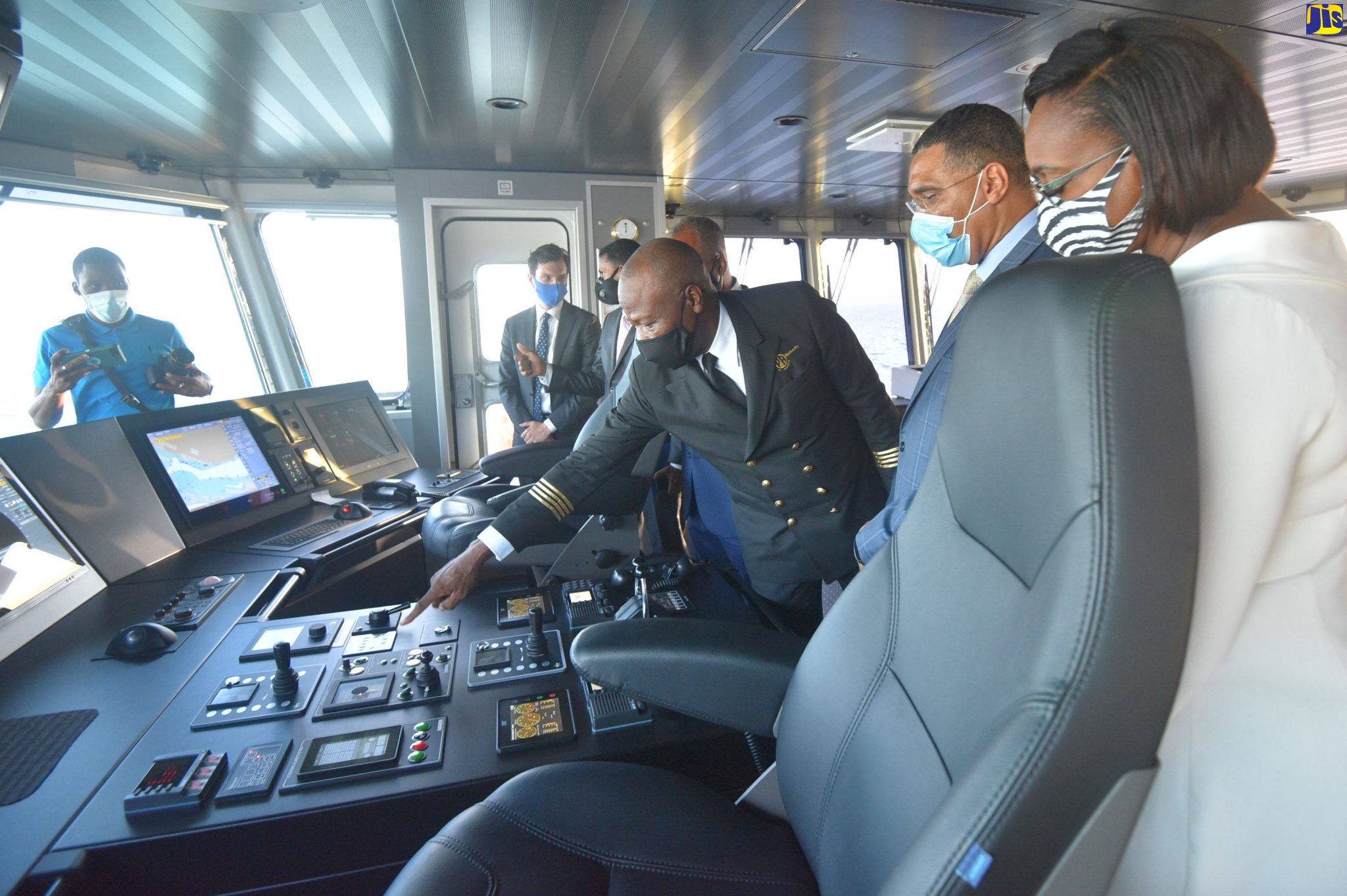 Prime Minister, the Most Hon. Andrew Holness (second right), and the Most Hon. Juliet Holness (right) look on as Captain Hugh Helps (3rd right) points out the features of the ‘Jamaica III’ control panel during the commissioning and christening ceremony for the vessel at Newport East, Kingston, on August 11.