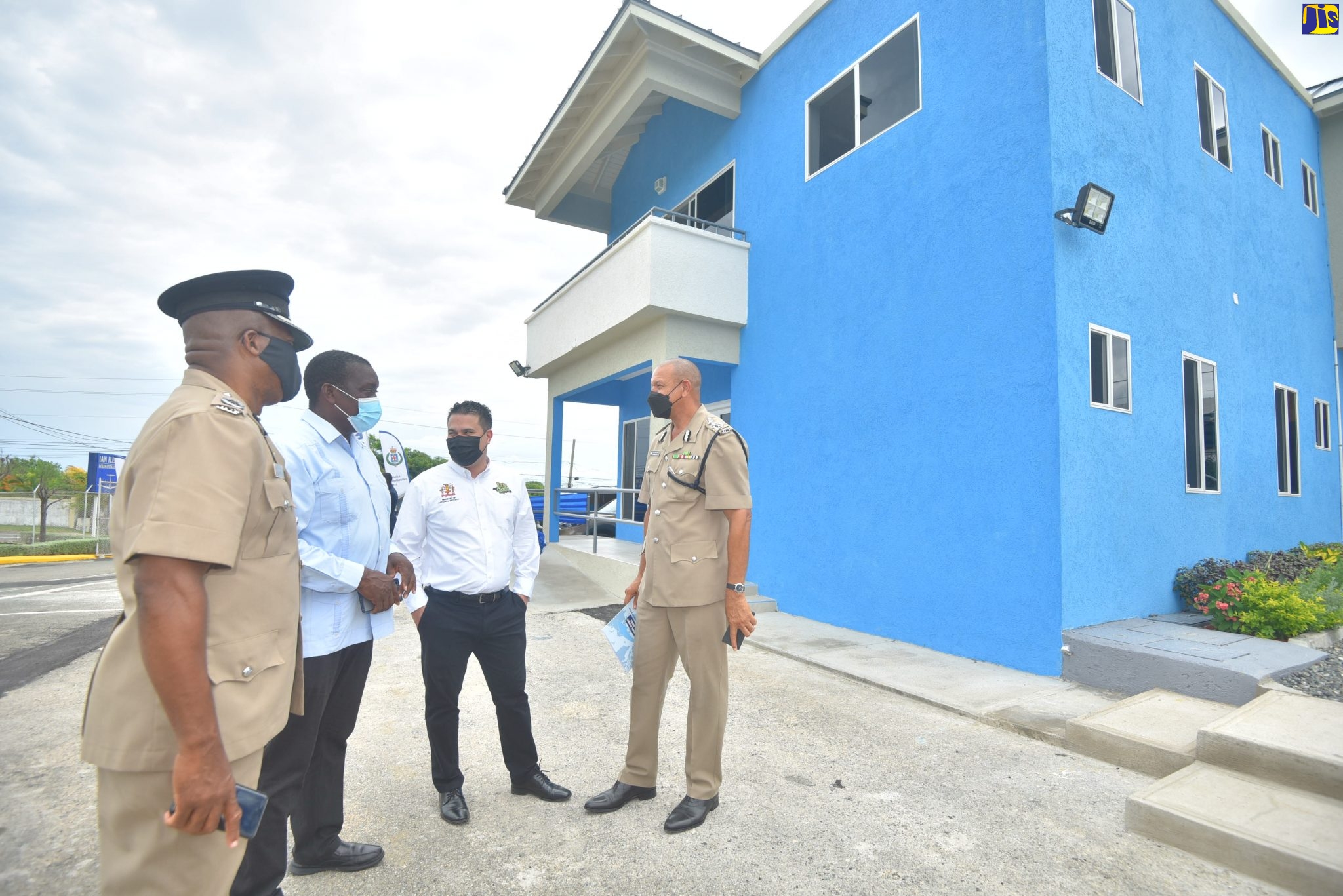 Minister of Transport and Mining, Hon. Robert Montague (2nd left), along with Minister without Portfolio, Ministry of National Security, Senator the Hon. Matthew Samuda (2nd right); and  Assistant Commissioner of Police, Calvin Allen (left), share in conversation with Deputy Commissioner of Police Clifford Blake at the official opening of the new police post at the Ian Fleming International Airport in St. Mary on August 13.

 