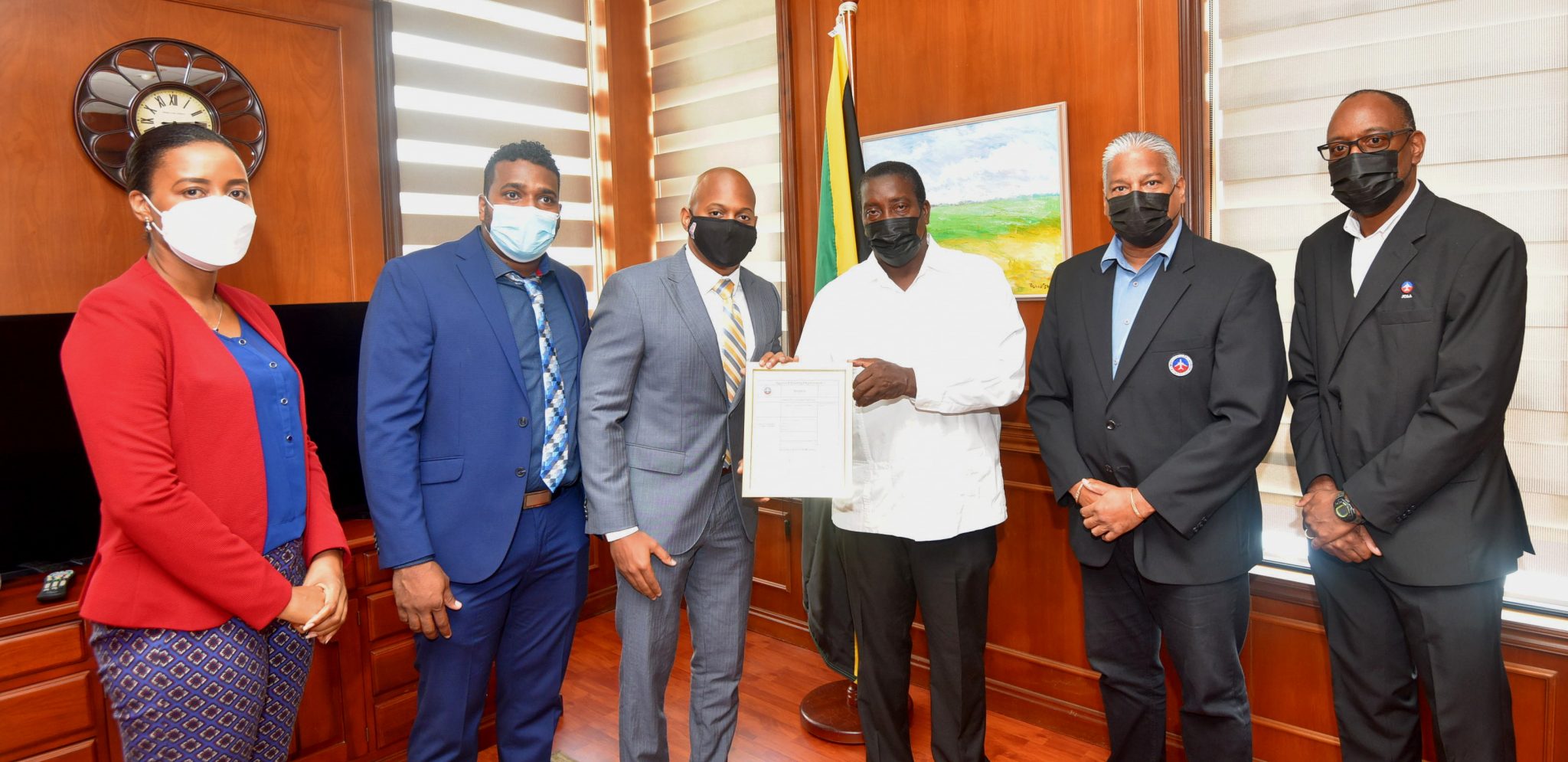 Minister of Transport and Mining Hon. Robert Montague (3rd right) presents the Approved Training Organisation (ATO) certificate to Accountable Manager of the Aeronautical School of the West Indies (ASWI) Mr. Gari-Paul Tomlinson (3rd left) at the Ministry of Transport and Mining on Thursday (August 19). Also participating in the handover exercise are (from left)  Senior Director, Transport Policy at the Ministry of Transport and Mining, Miss Tanya Beward,  Maintenance Director, ASWI  Mr. Christopher Gooding, Director-General of the Jamaica Civil Aviation Authority (JCAA)  Mr. Nari Williams-Singh and Director of Flight Safety at the JCAA, Mr. Noel Ellis. 