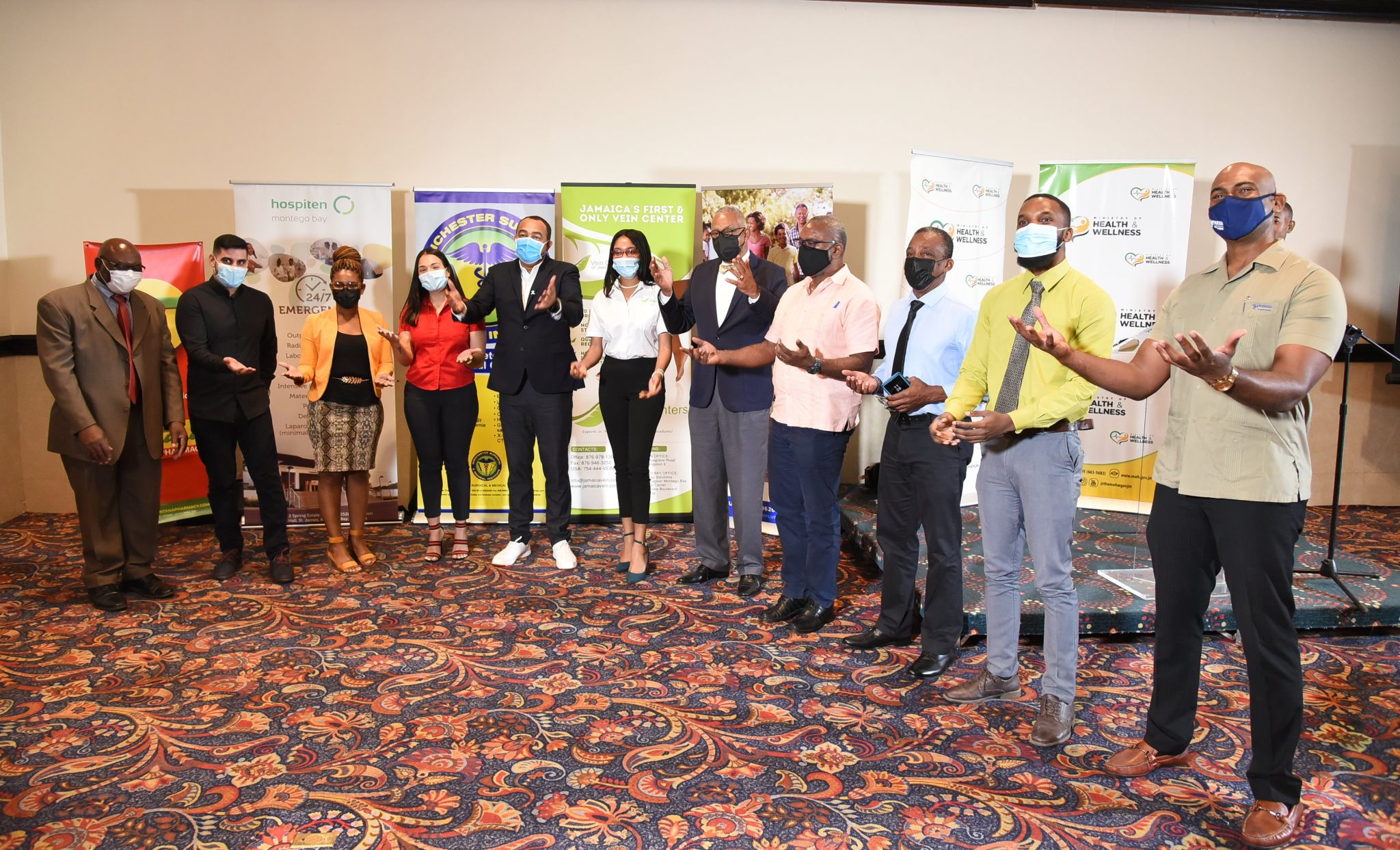 Minister of Health and Wellness, Dr. the Hon. Christopher Tufton (fifth left), shares a moment with representatives of private entities that will be administering the coronavirus (COVID-19) vaccines to Jamaicans at sites across the island, during the signing ceremony held on Monday (September 27), at The Jamaica Pegasus hotel in New Kingston.


