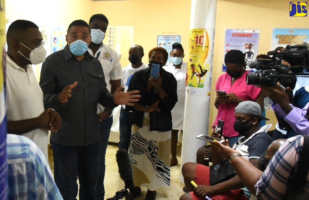 Prime Minister, the Most Hon. Andrew Holness (second left) addresses residents inside the Mocho Health Centre in Clarendon during a vaccination sensitisation tour on Thursday (October 7). He is flanked by Member of Parliament for Clarendon North Central  and State Minister for Education, Youth and Information,  Hon. Robert Nesta Morgan (left), and Councillor for the Mocho Division, Romaine Morris.