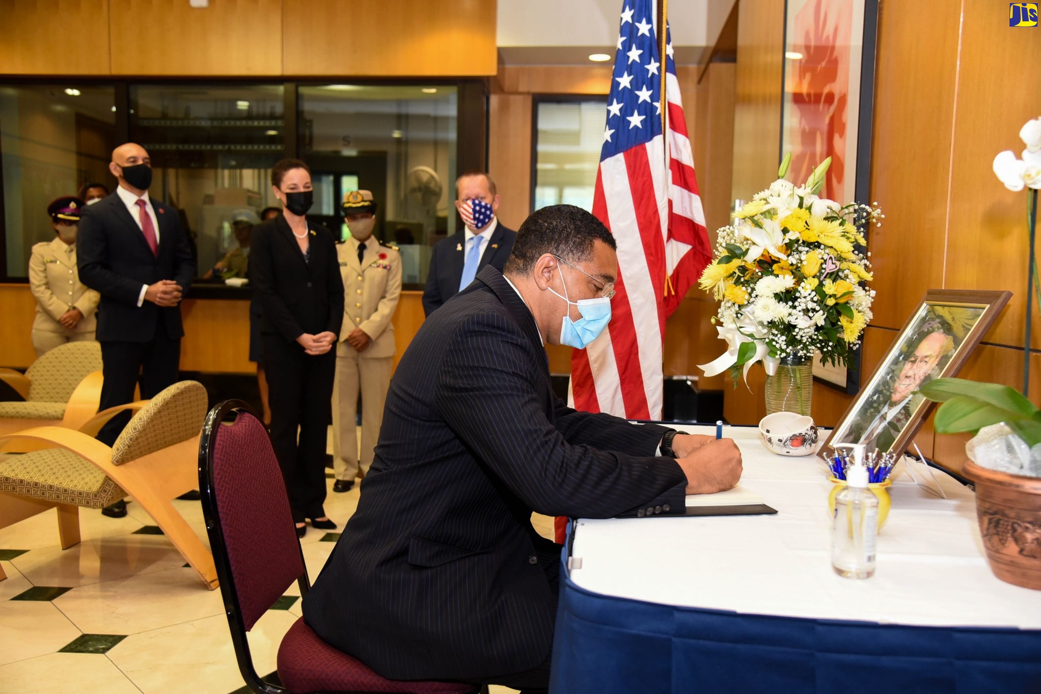 Prime Minister, the Most Hon. Andrew Holness, signs the condolence book for the late former United States (US) Secretary of State, General Colin L. Powell, during a wreath-laying ceremony at the US Embassy in Kingston on Thursday (October 21). Observing (from left) are Commissioner of Police, Major General Antony Anderson; Minister of Foreign Affairs and Foreign Trade, Senator the Hon. Kamina Johnson Smith; and Chargé d’ Affaires, US Embassy,  John McIntyre. General Colin Powell was appointed Secretary of State by President George W. Bush on January 20, 2001, after being unanimously confirmed by the US Senate. He served for four years, leaving the position on January 26, 2005. He was the first African-American to serve as US Secretary of State. General Powell died on October 18.