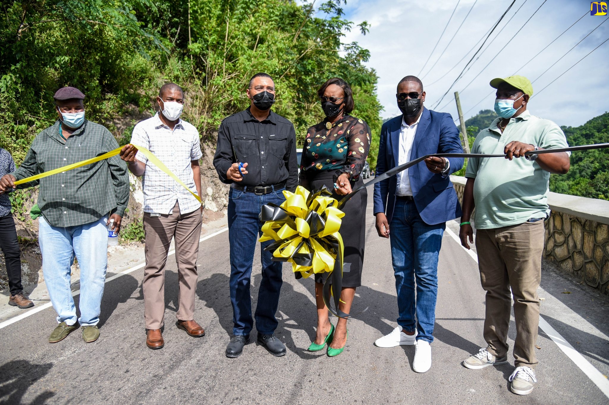 Prime Minister the Most Hon. Andrew Holness (3rd left) and Member of Parliament for East Rural St. Andrew, the Most Hon Juliet Holness (3rd right) cut the ribbon symbolizing the official reopening of the Gordon Town main road in St. Andrew, on October 29. Others from left are: Project Manager, National Works Agency (NWA), Caswell Whyte; Senior Director, Project Implementation, NWA, Varden Downer; Managing Director of Kinetic Engineering Services, Keon Hinds; and Councillor for the Gordon Town Division, Neville Whittaker.