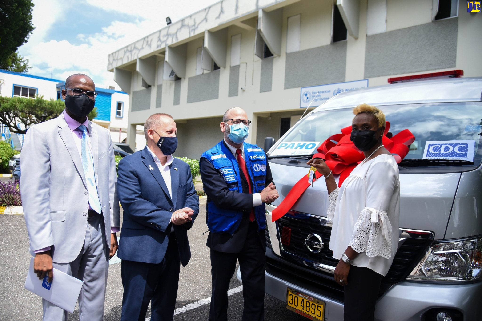 Minister of State in the Ministry of Health and Wellness, Hon. Juliet Cuthbert-Flynn (right), displays the keys for a 16-seater minibus, donated by the Centers for Disease Control and Prevention (CDC) and the Pan American Health Organization (PAHO) to support the country’s coronavirus (COVID-19) response. The bus was among items handed over at the PAHO office located at the  Mona Campus of the University of the West Indies (UWI) on Thursday (October 7). Sharing the moment (from left) are Director of the Caribbean Regional Office, CDC, Dr. Varough Deyde; Chargé d’Affaires, United States Embassy in Kingston, John McIntyre; and PAHO/World Health Organization (WHO) Representative for Jamaica, Bermuda and the Cayman Islands, Ian Stein.
