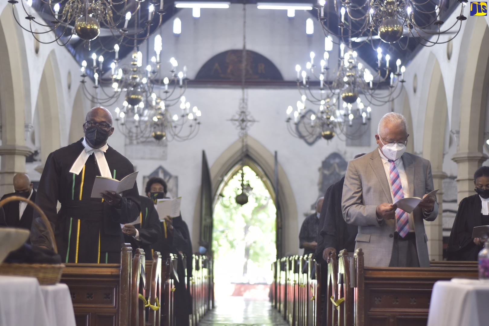 Minister of Justice, Hon. Delroy Chuck (right), and Chief Justice, Bryan Sykes (left), join in the singing of a hymn during the Annual Assize Church Service to mark the Opening Session of the Michaelmas Term of the Home Circuit Court, at the St. Andrew Parish Church on Sunday (October 24).