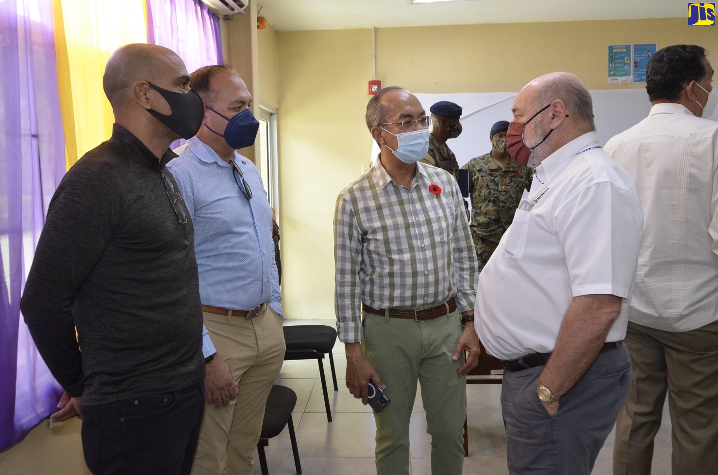 Minister of National Security, Hon. Dr. Horace Chang (second right), listens to a comment from Managing Director of Barnett Limited in St. James, Mark Kerr-Jarrett (right), during a visit to the Caribbean Military Academy in Flanker, St. James, on Thursday (October 14) where 30 at-risk young men are being trained to operate trucks and other heavy-duty vehicles. The training is being offered under the Ministry’s Articulated Truck Driving Programme in partnership with the Jamaica Defence Force (JDF) and the HEART/NSTA Trust.  Sharing in the conversation (from left) are Executive Deputy Chairman of Chukka Caribbean Adventures, John Byles; and Margaritaville Caribbean Group (MCG) Founder and Chairman, Ian Dear. 