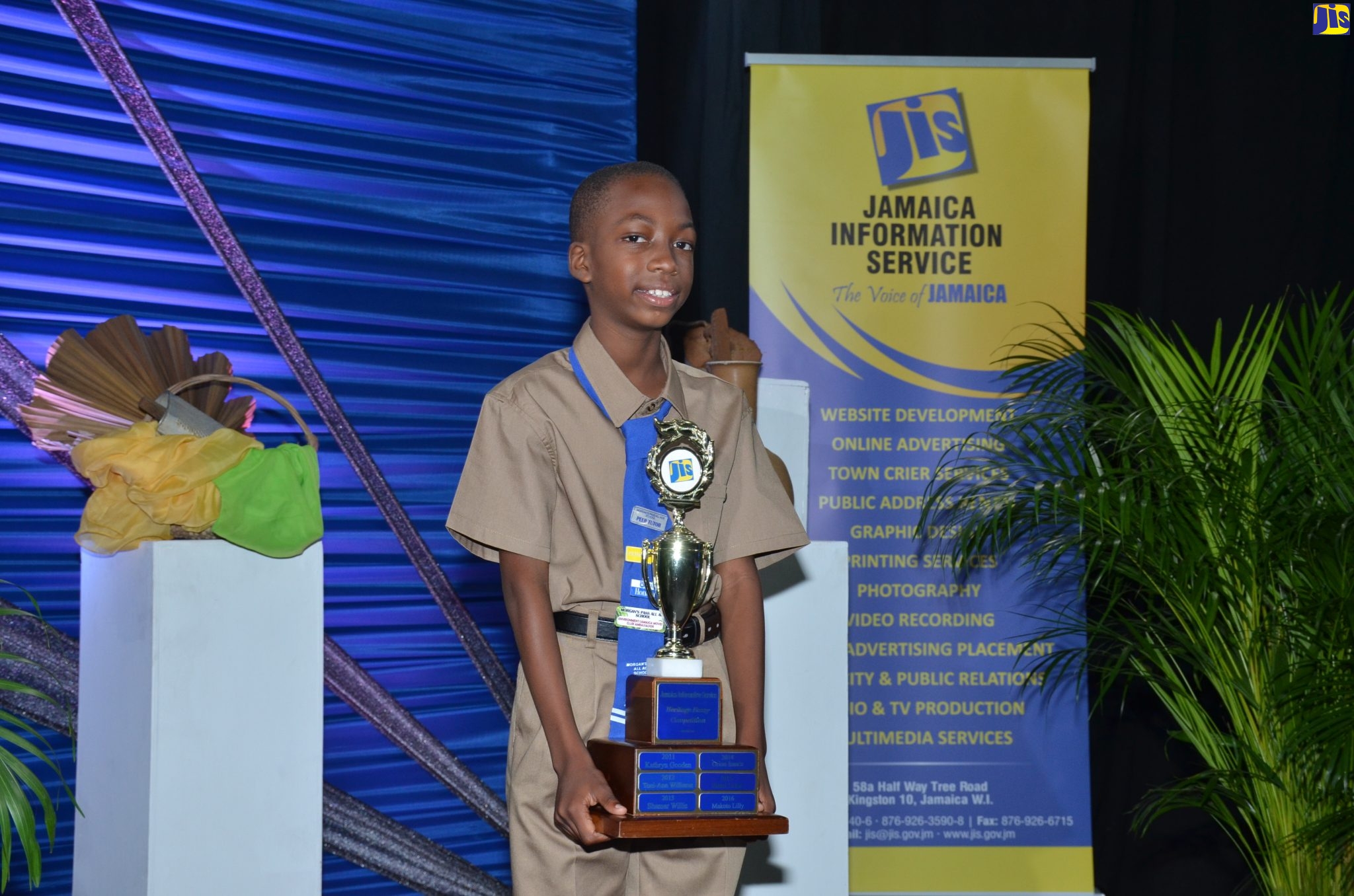 Amani Shrouder, student of the Morgan Pass Primary School in Clarendon, poses with his trophy after he was declared winner of  the Essay component of  JIS 2020 Heritage Competition.