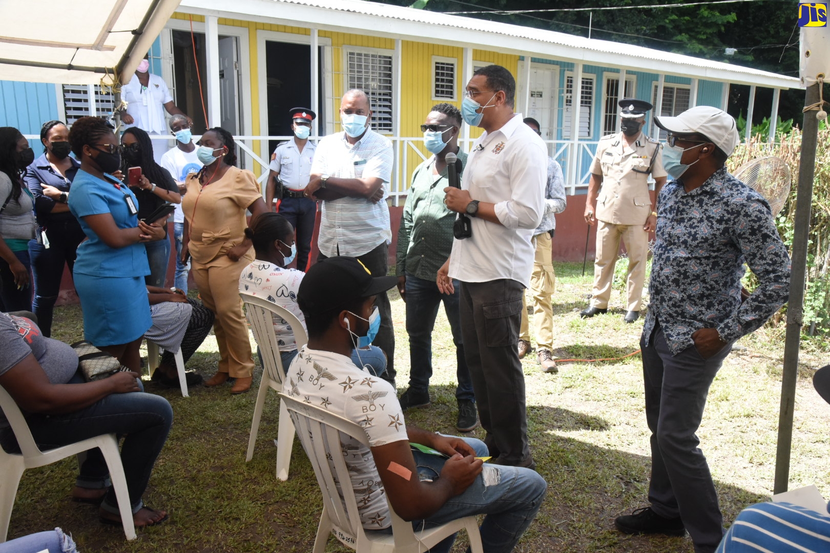 Prime Minister, the Most Hon. Andrew Holness (second right), addresses a vaccination exercise at the Castleton Health Centre in St. Mary on Friday  (October 15). At right is Member of Parliament for South East St. Mary, Hon. Dr. Norman Dunn, while other officials look on.