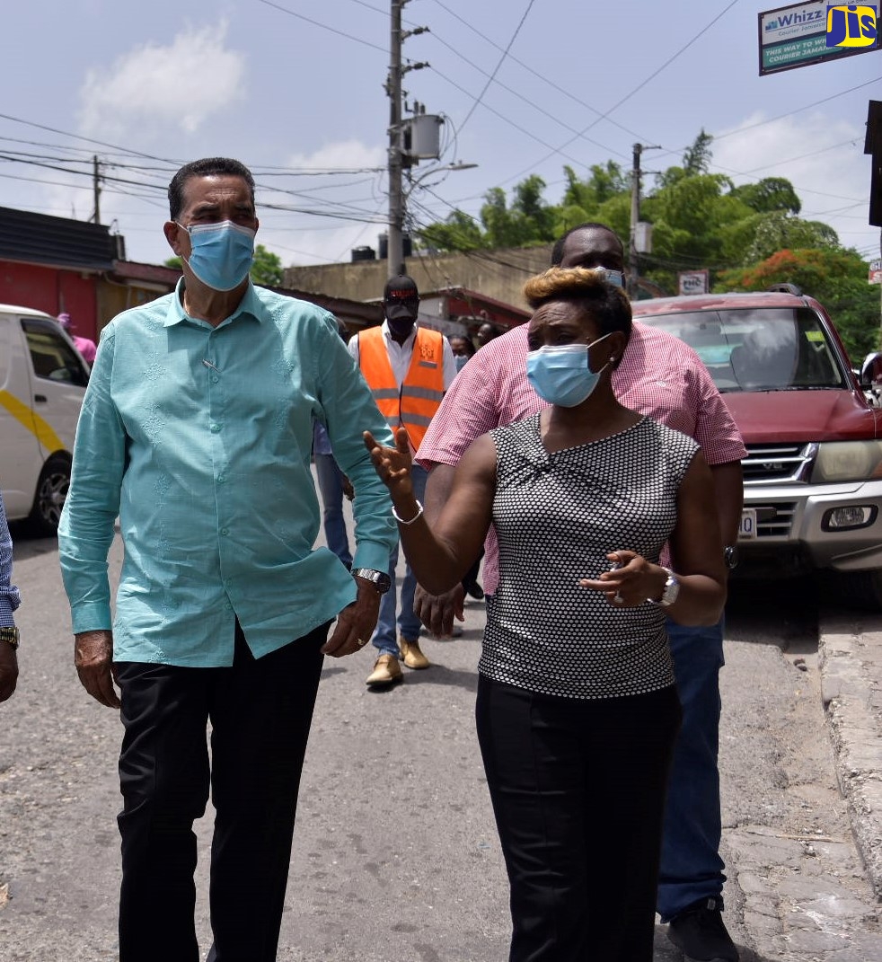 State Minister, Ministry of Local Government and Rural Development, Hon. Homer Davis, converses with Minister of State for Health and Wellness and Member of Parliament, St. Andrew West Rural, Juliet Cuthbert- Flynn, during a tour of the Lawrence Tavern Division, recently. Lawrence Tavern is one of five communities selected for upgrading under the $650-Million Rural Development Programme.