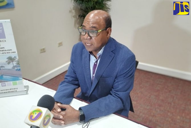 Tourism Minister, Hon. Edmund Bartlett, speaks at a tablet and laptop handover ceremony at the Holiday Inn Resort and Spa in St. James, on October 8.