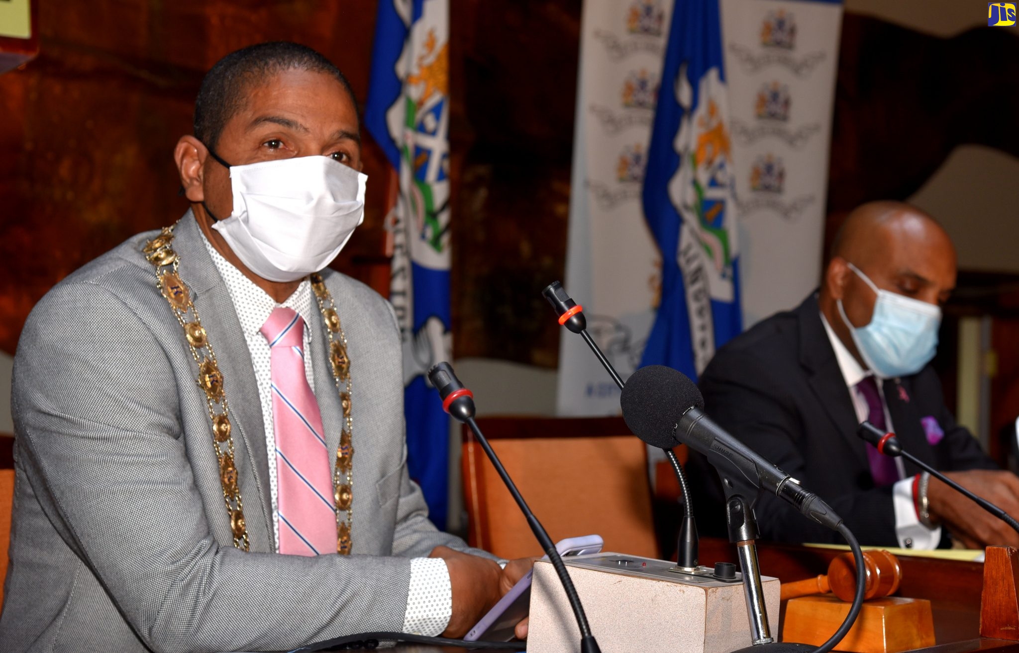 Mayor of Kingston, Senator Councillor Delroy Williams (left), addresses the monthly meeting of the Kingston and St. Andrew Municipal Corporation (KSAMC), on Tuesday (October 12), at the Jamaica Conference Centre, downtown Kingston. At right is Chief Executive Officer of the Corporation, Robert Hill.