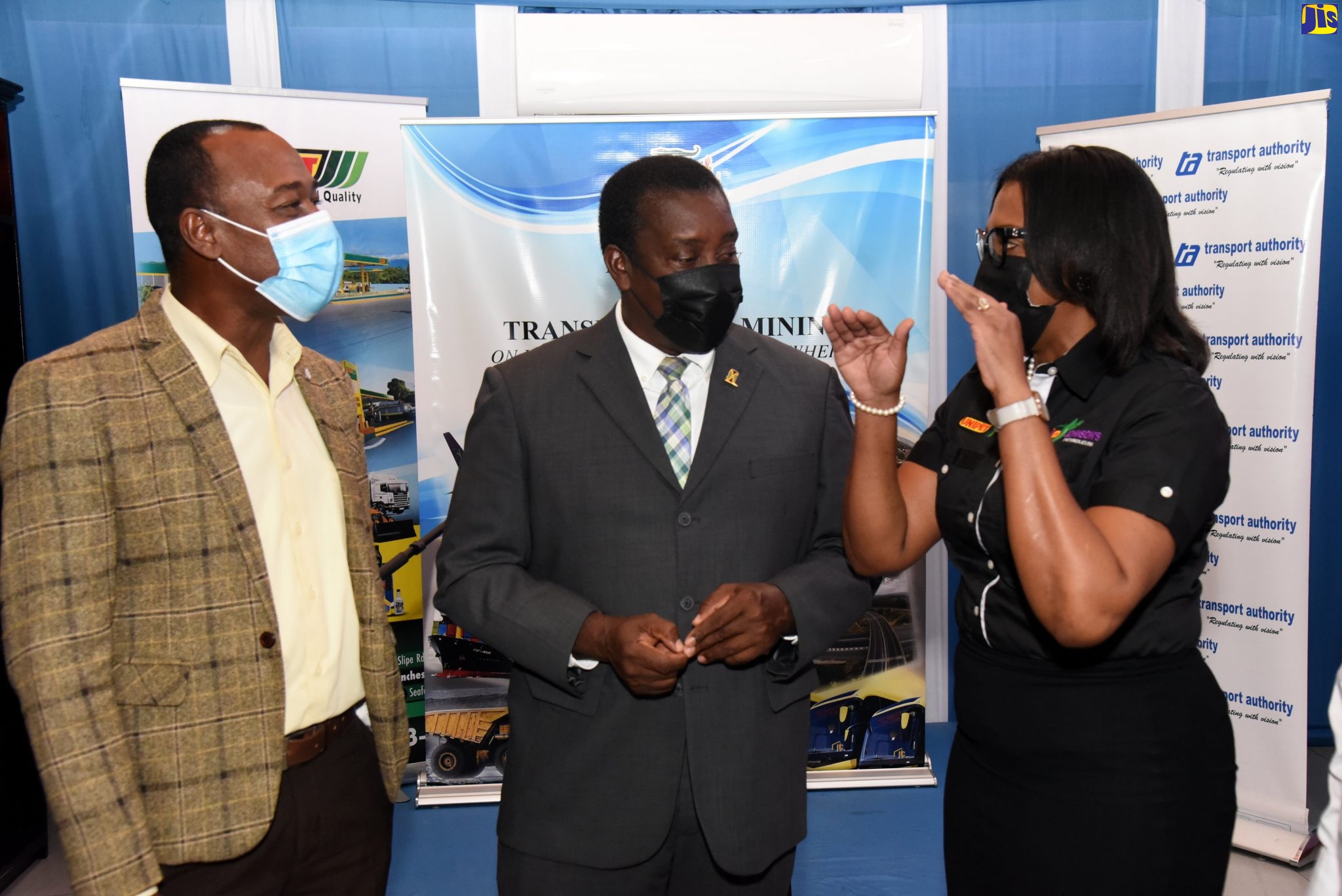 Minister of Transport and Mining, Hon. Robert Montague (centre), and Managing Director of the Transport Authority, Willard Hylton (left), listen keenly to Business Development Manager at Johnson’s Petroleum and United Co. Ltd., Bridgette Wright, at the launch of the Transport Operators COVID-19 Initiative, at the Ministry of Transport and Mining, on Tuesday, October 5.
