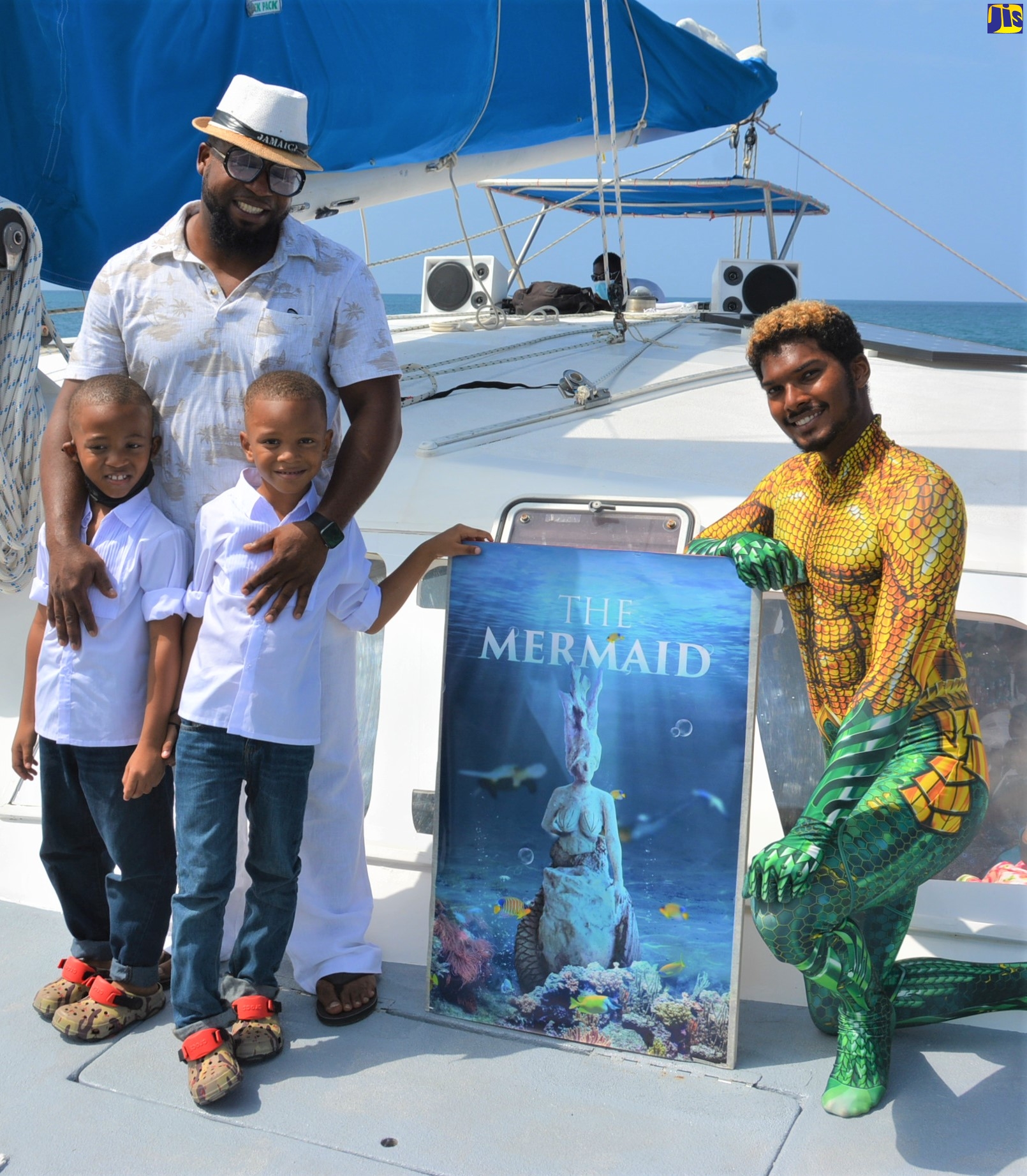 Environmental Sculptor, Robert “Toby” Grant (left), who created the mermaid figure at the Montego Bay Marine Park and his sons (left to right) Antione and Zion, share a moment with Jahqua Man, Christopher May at the unveiling of the 226.796-kilogram (500-pound) mermaid at the park on Saturday (October 23).