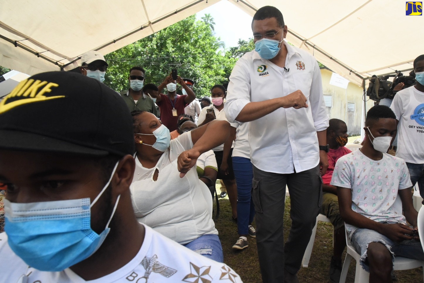 Prime Minister, the Most Hon. Andrew Holness (centre), greets residents during a vaccination blitz held recently at the Castleton Health Centre in St. Mary.