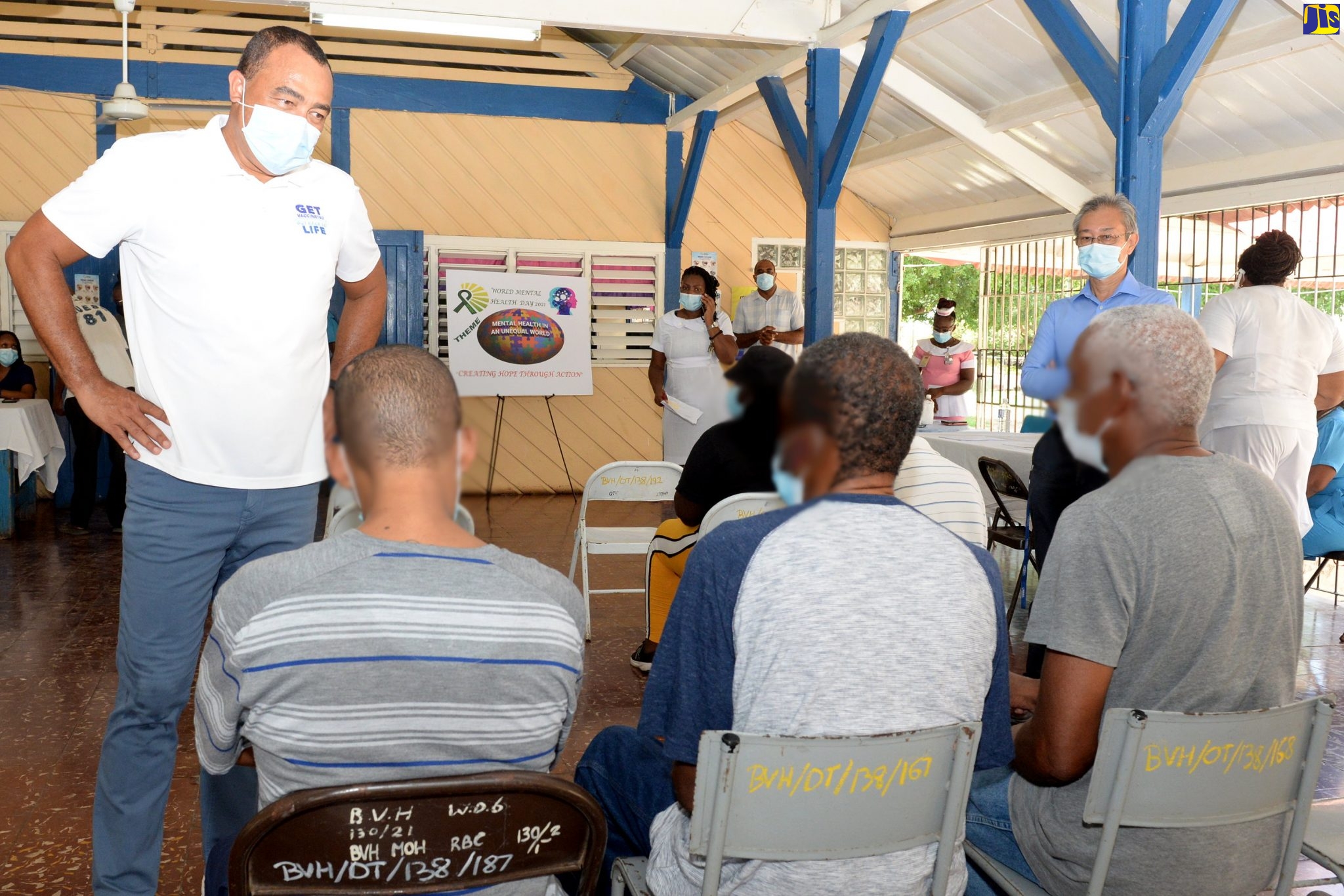 Minister of Health and Wellness, Dr. the Hon. Christopher Tufton (left), converses with patients at the Bellevue Hospital in Kingston, during a coronavirus (COVID-19) vaccination blitz at the institution on Wednesday (October 13). More than 300 long-stay patients were slated to be vaccinated.